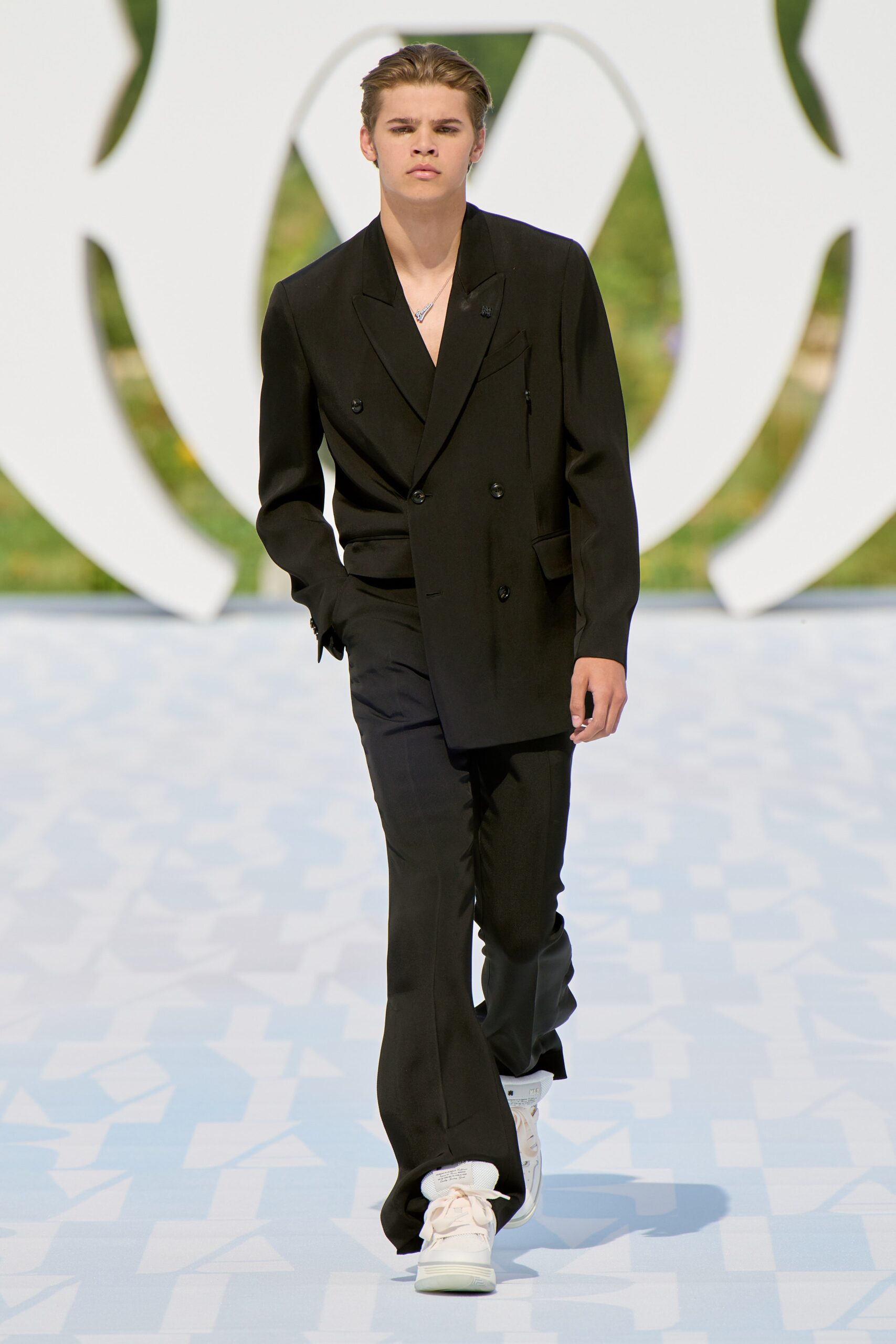 black tailored suit with white sneakers