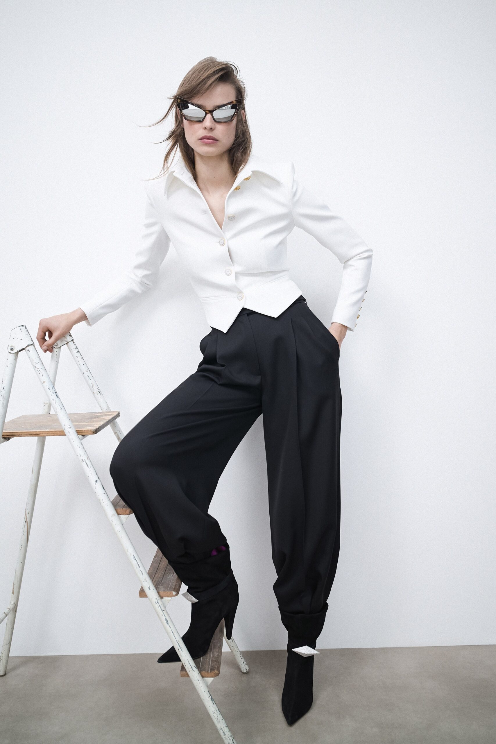 white fitted blazer and black relaxed pants