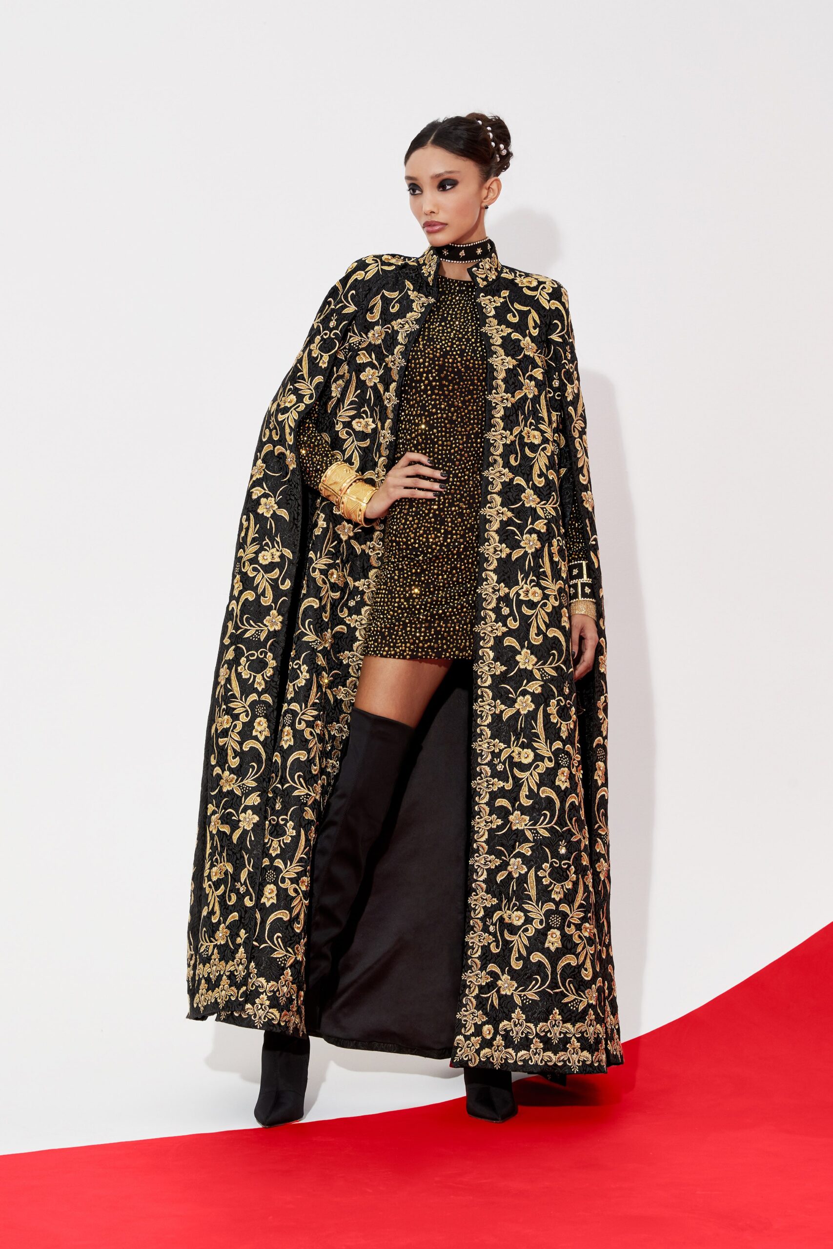 black and gold embroidered dress and cape