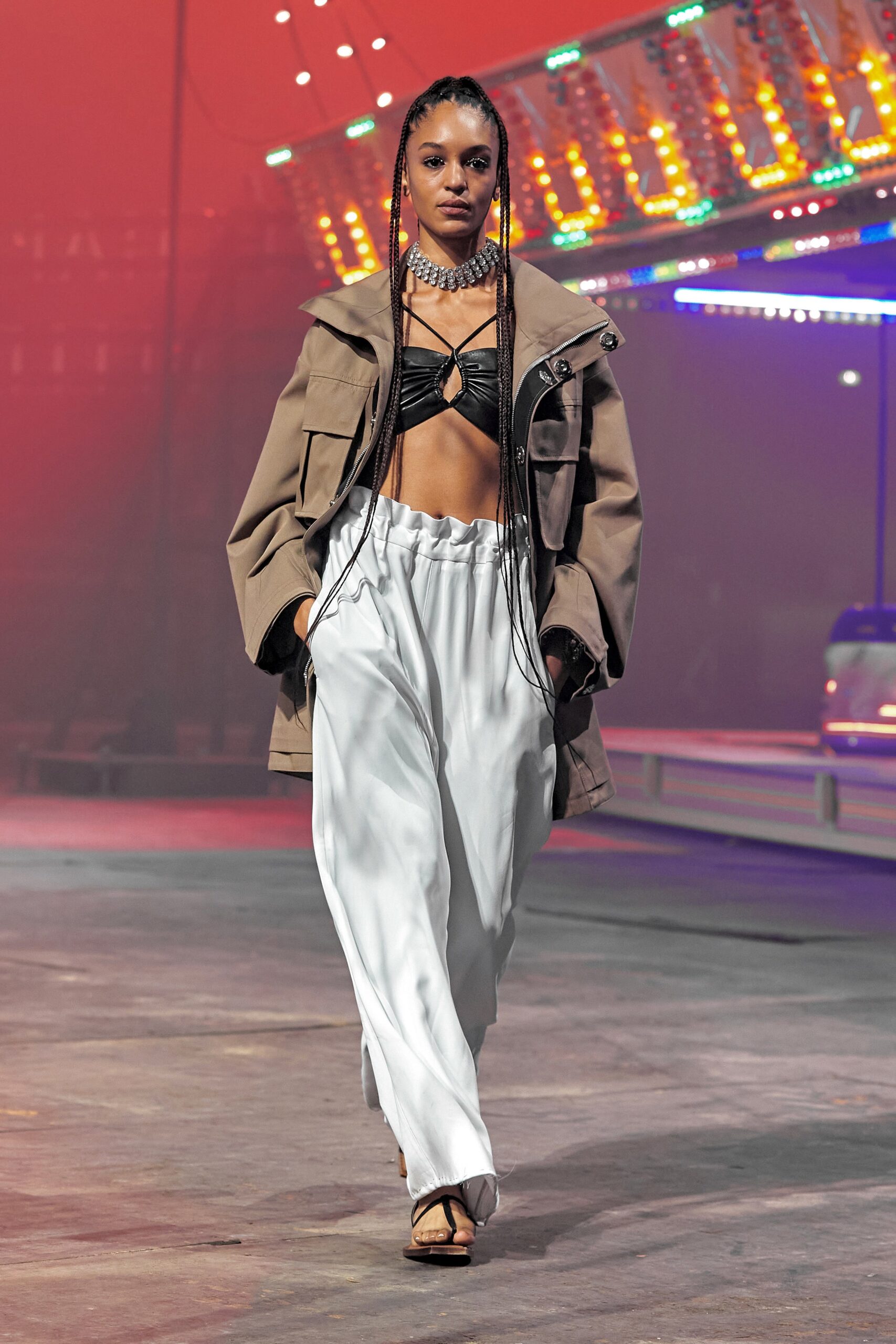 beige jacket black top white pants