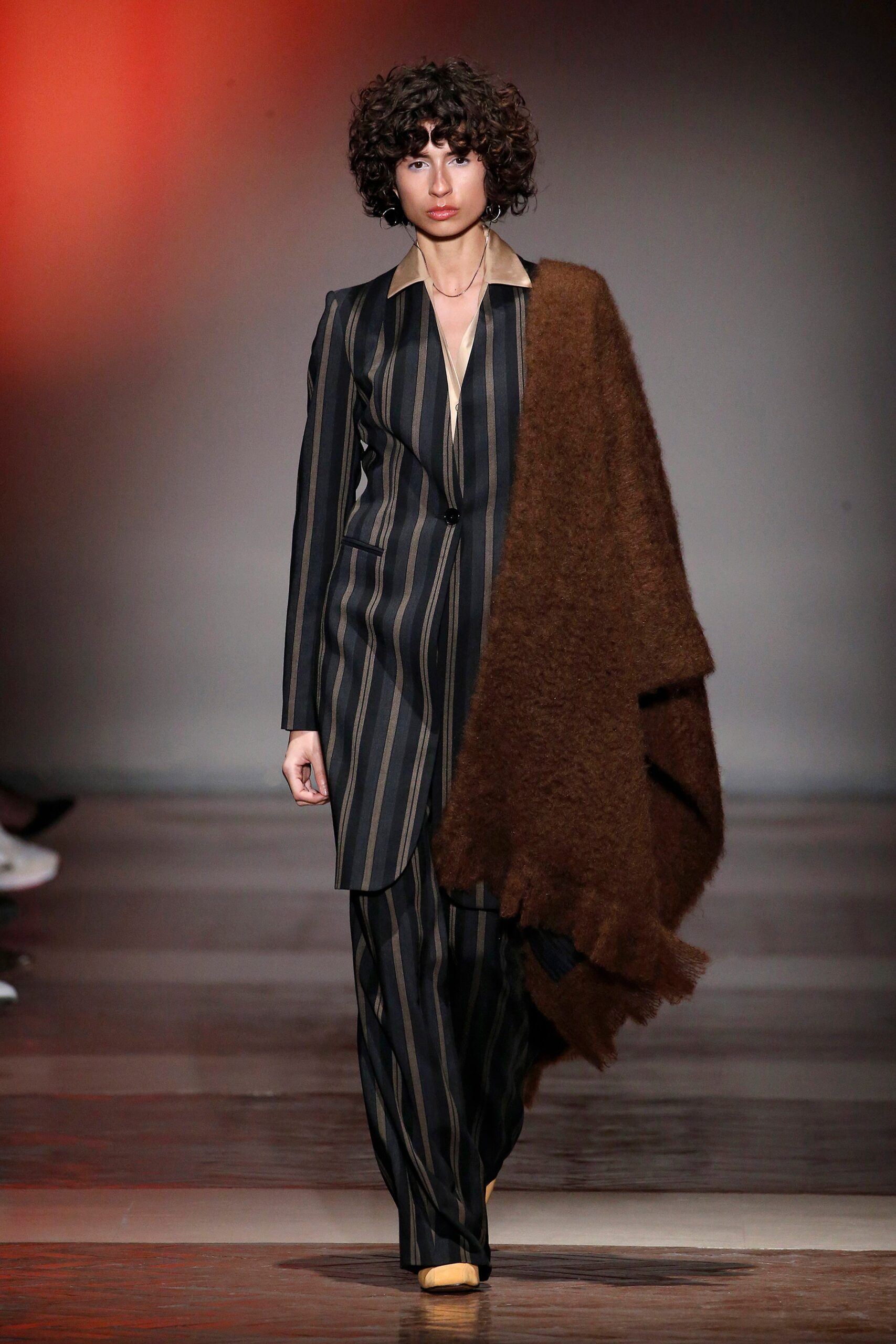 tailored striped suit with oversized scarf