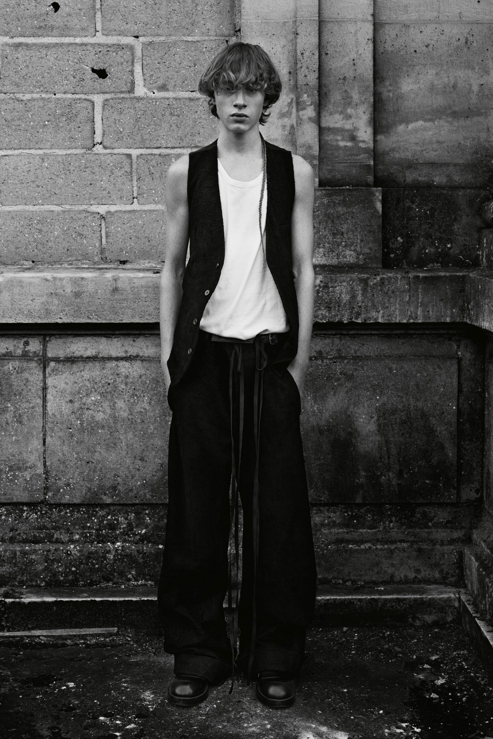 black vest white t-shirt black pants