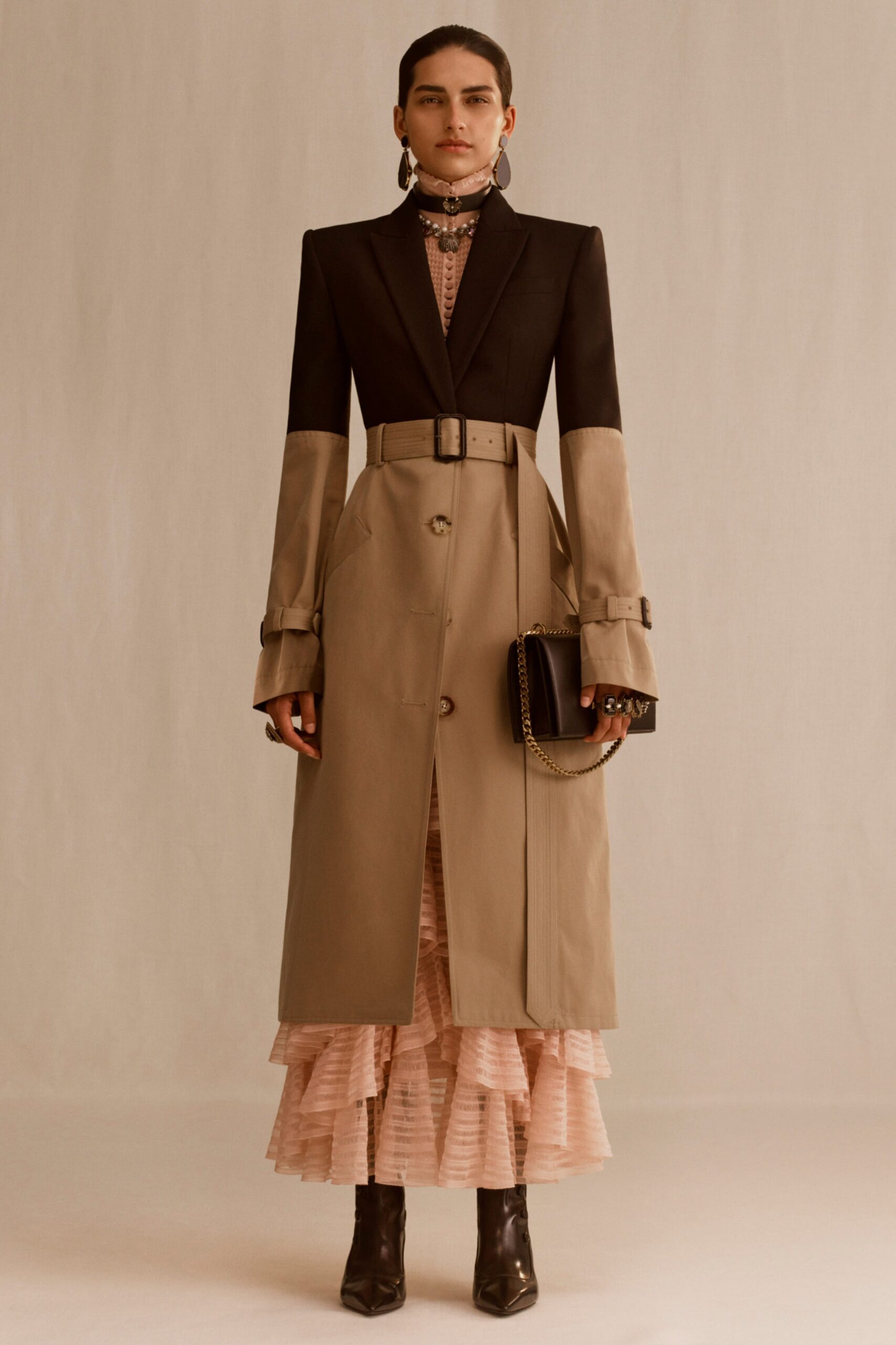black and beige tailored trench coat with pink tiered dress