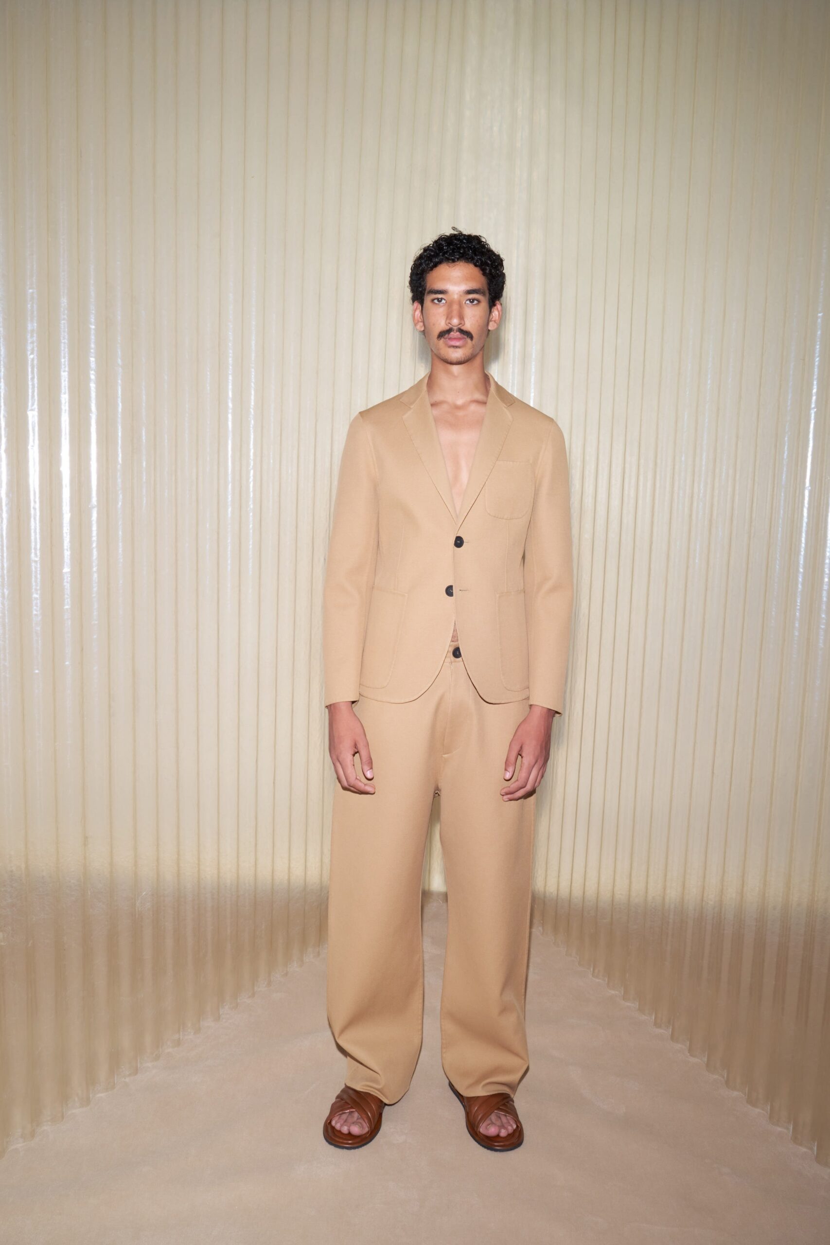 beige tailored suit with brown shoes