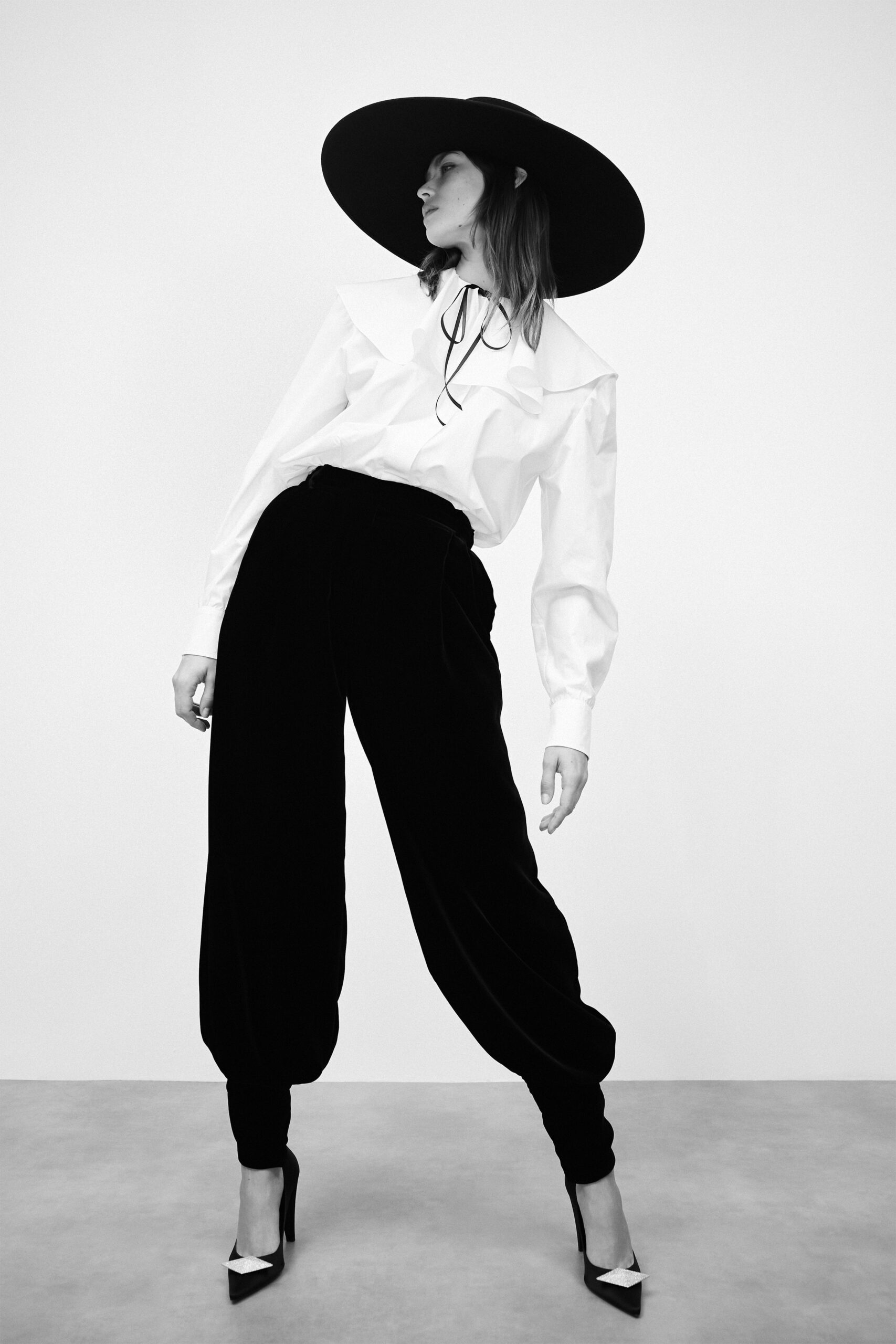 white relaxed shirt and black velvet pants