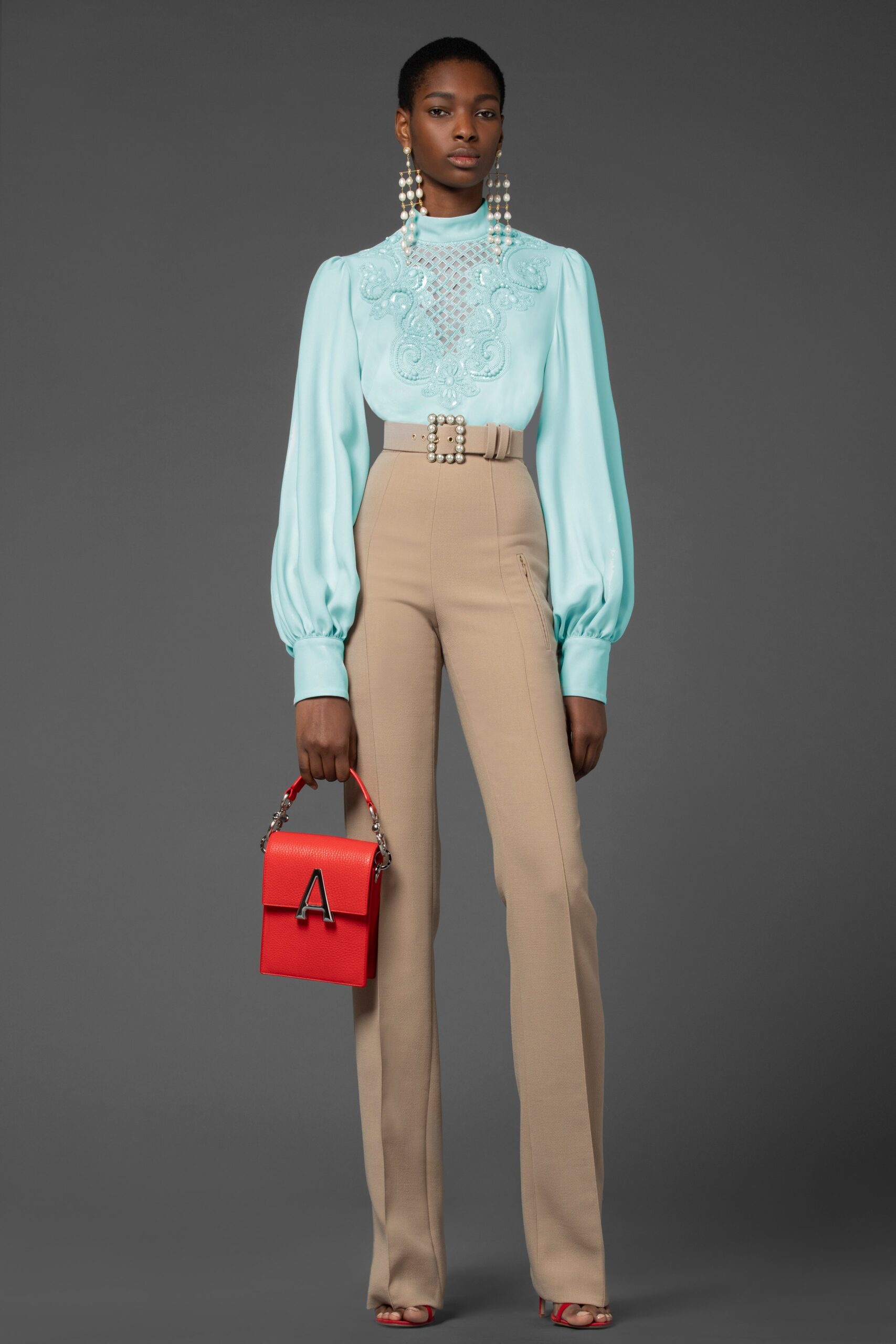 blue silk blouse with beige tailored pants
