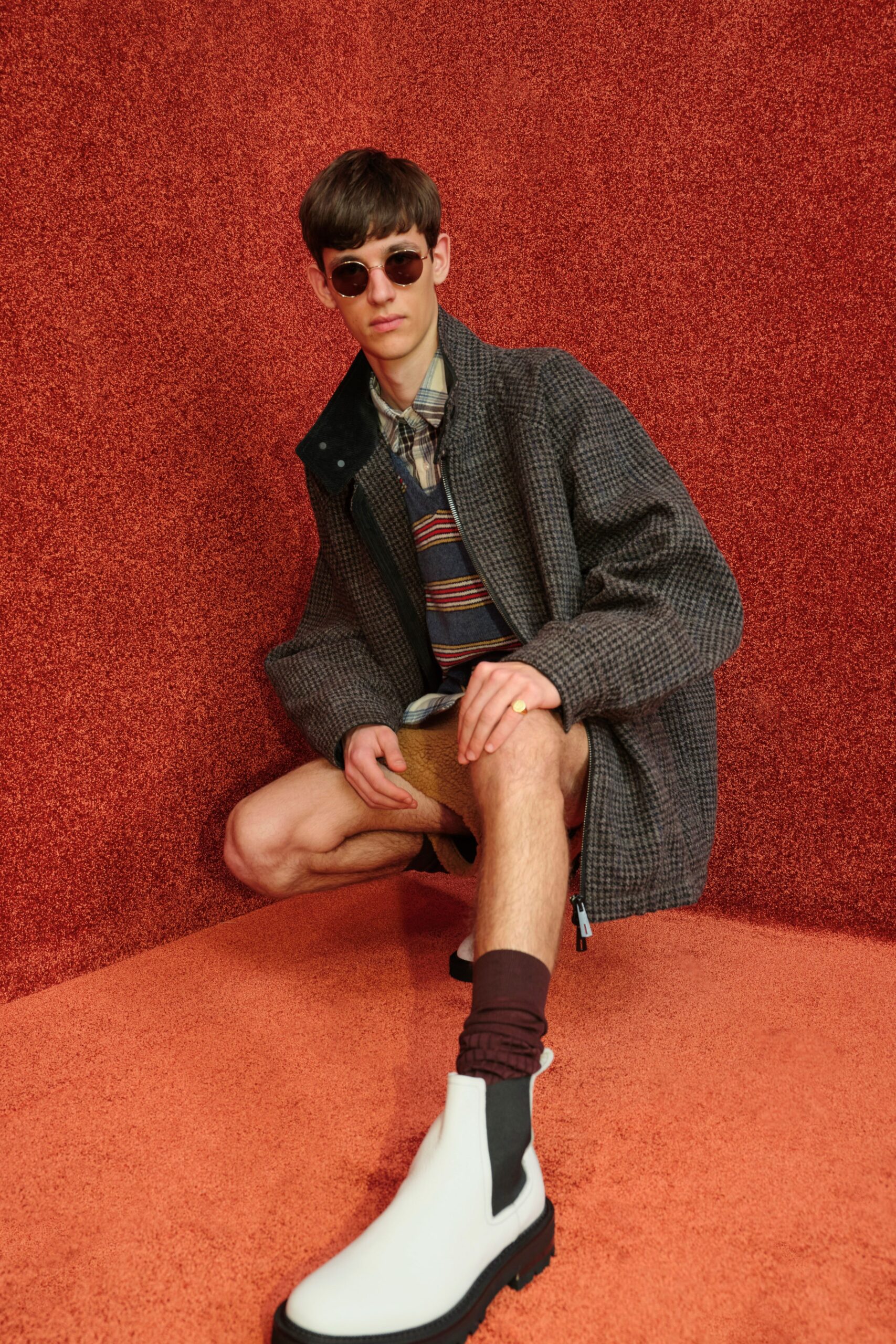 gray coat with multi-striped shirt