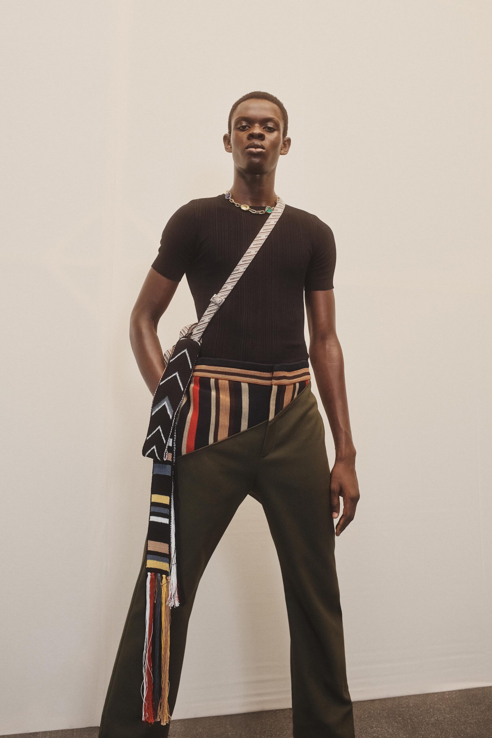 black fitted top with green pants