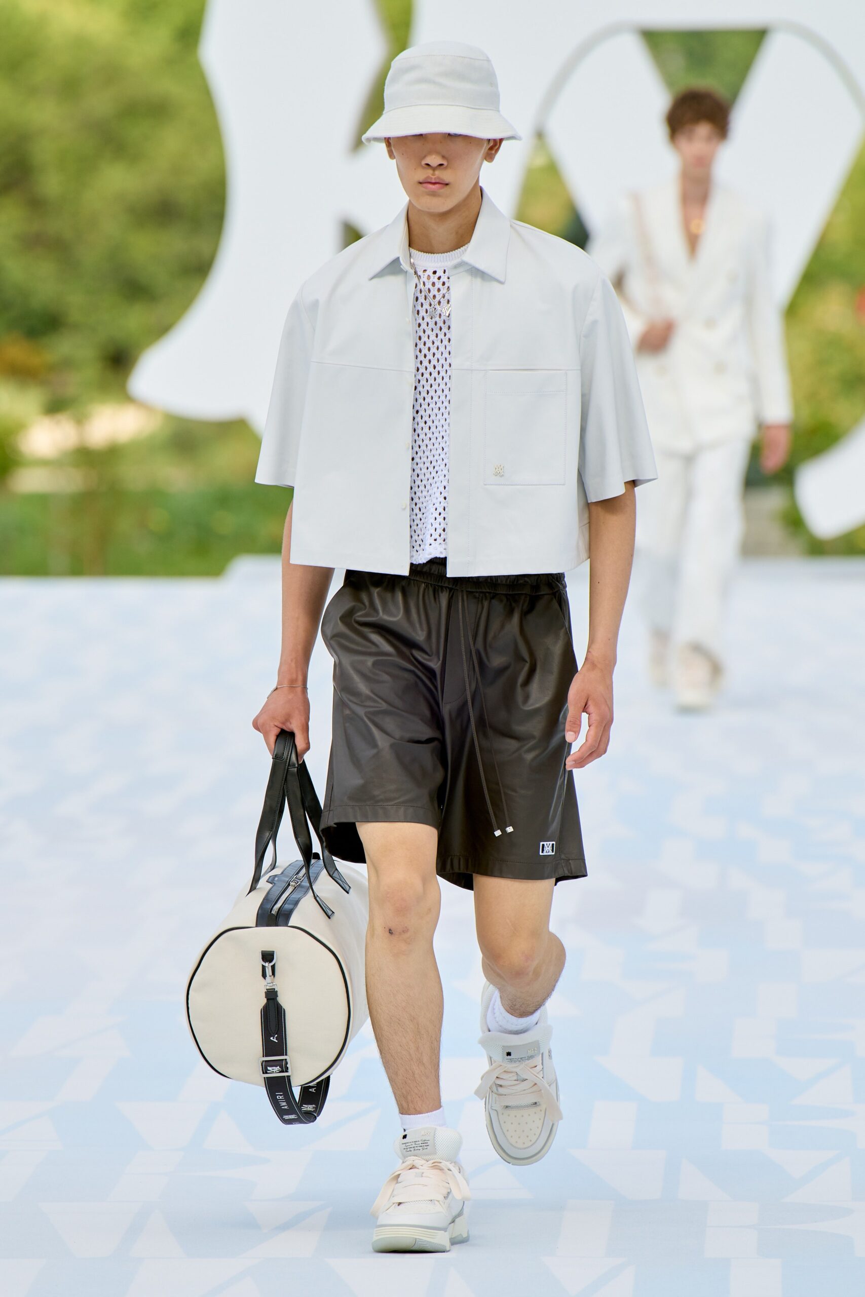 white relaxed shirt with black leather shorts