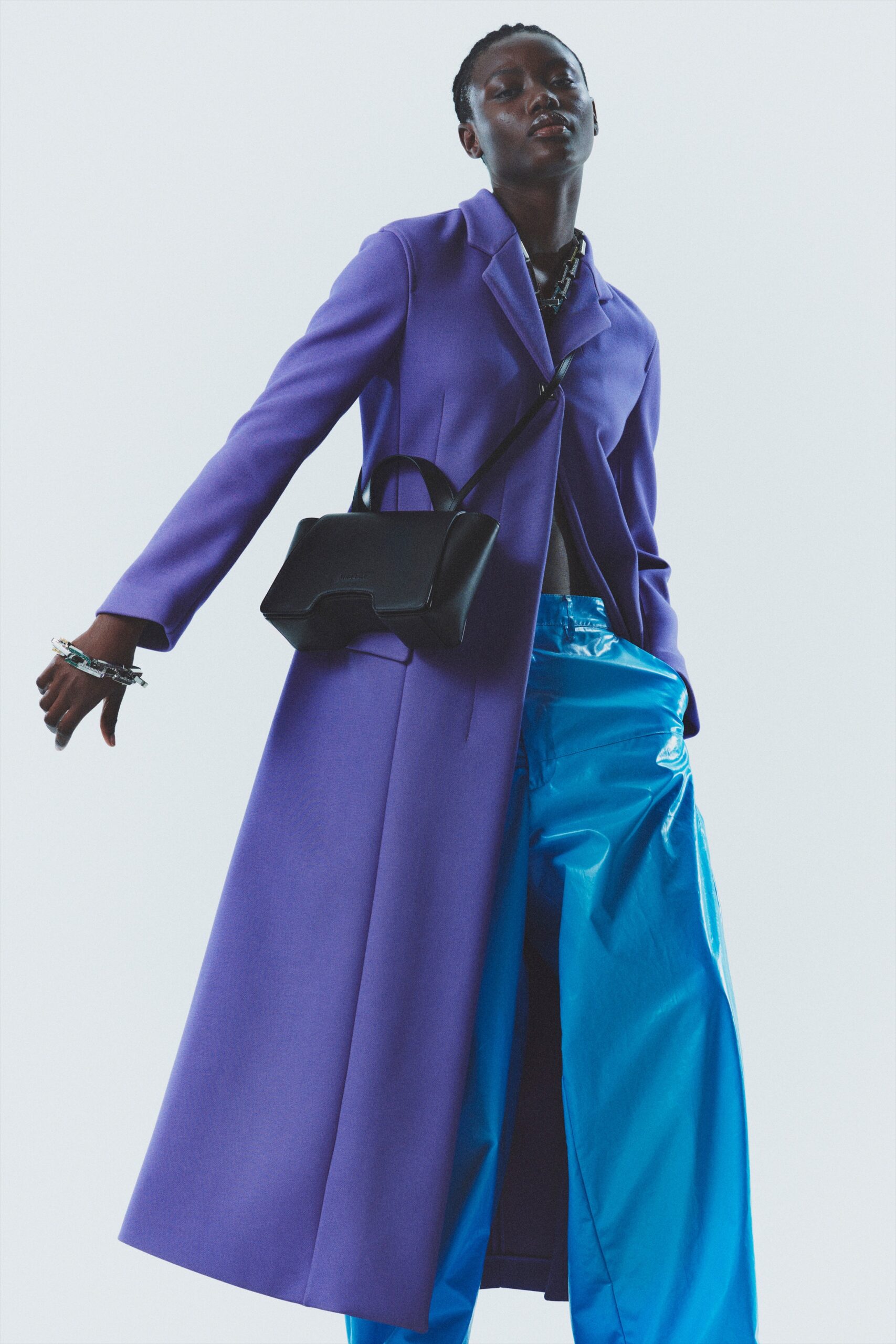 purple wool coat and blue vinyl pants