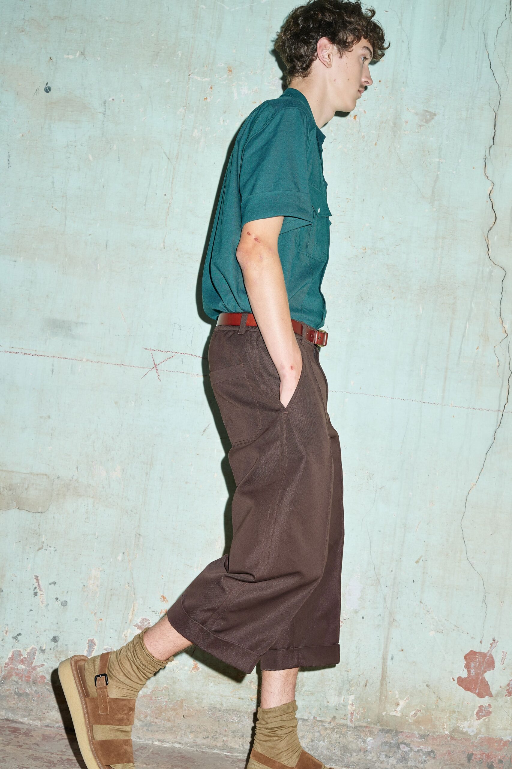teal shirt and brown pants