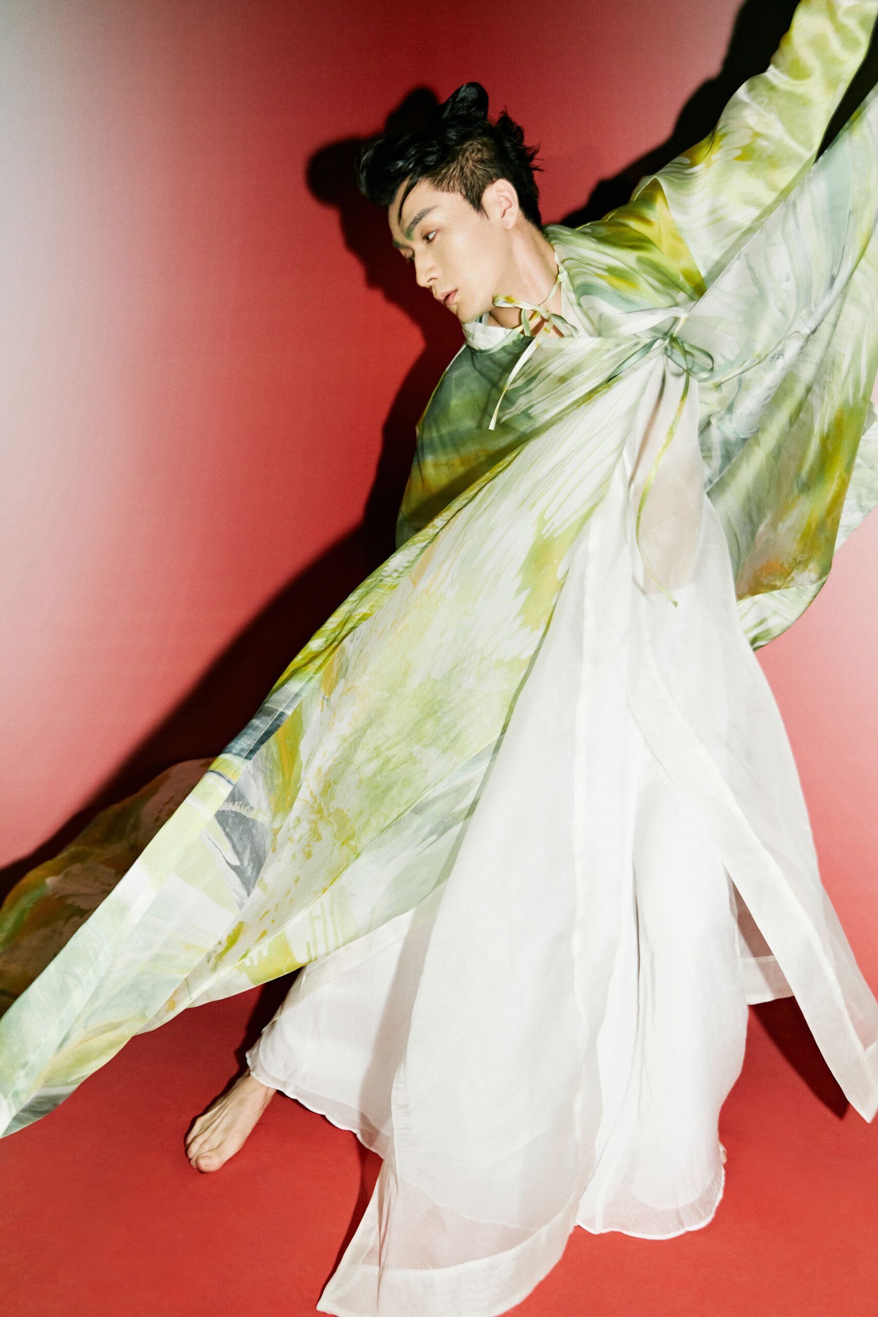 flowing white silk maxi dress and green cape