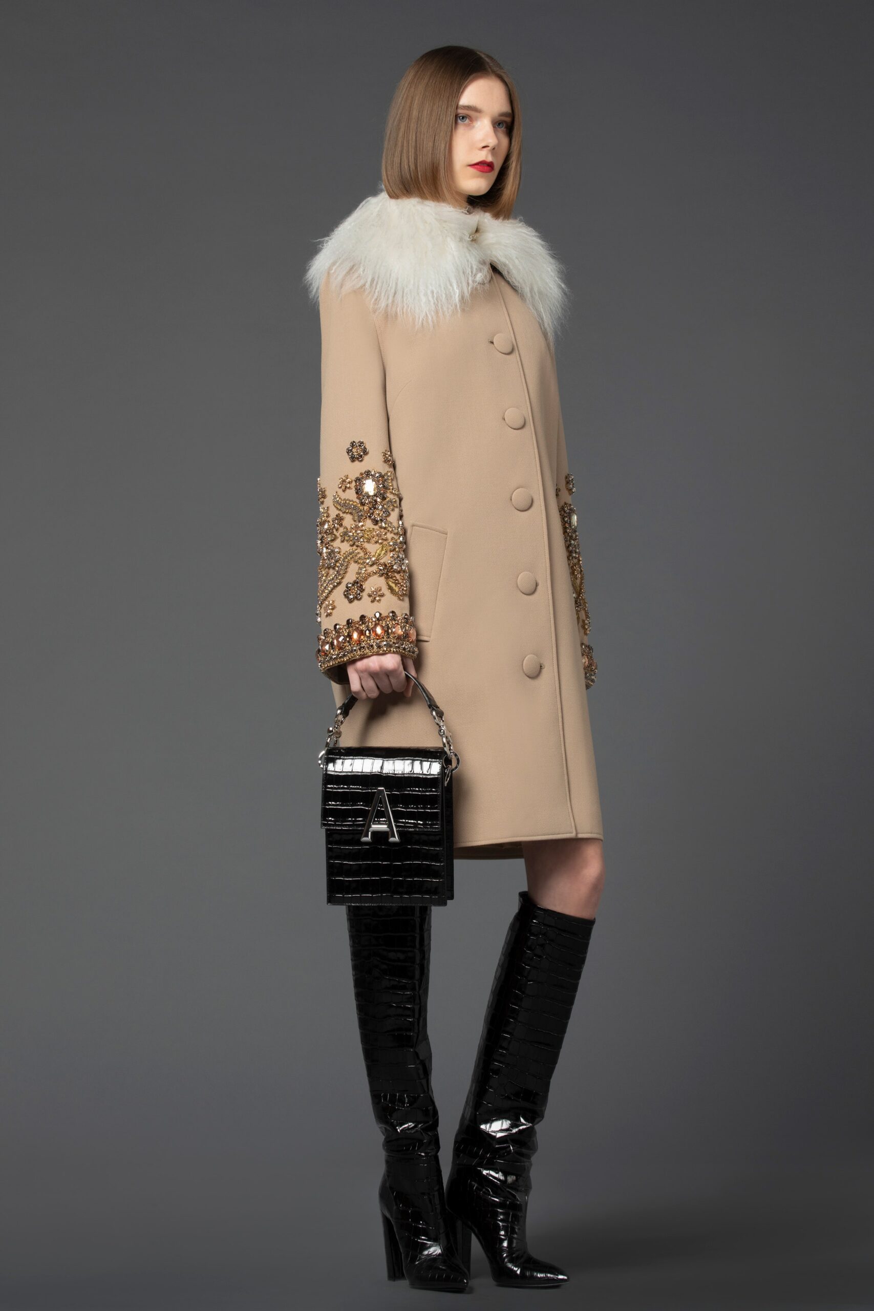 beige embroidered coat with black boots