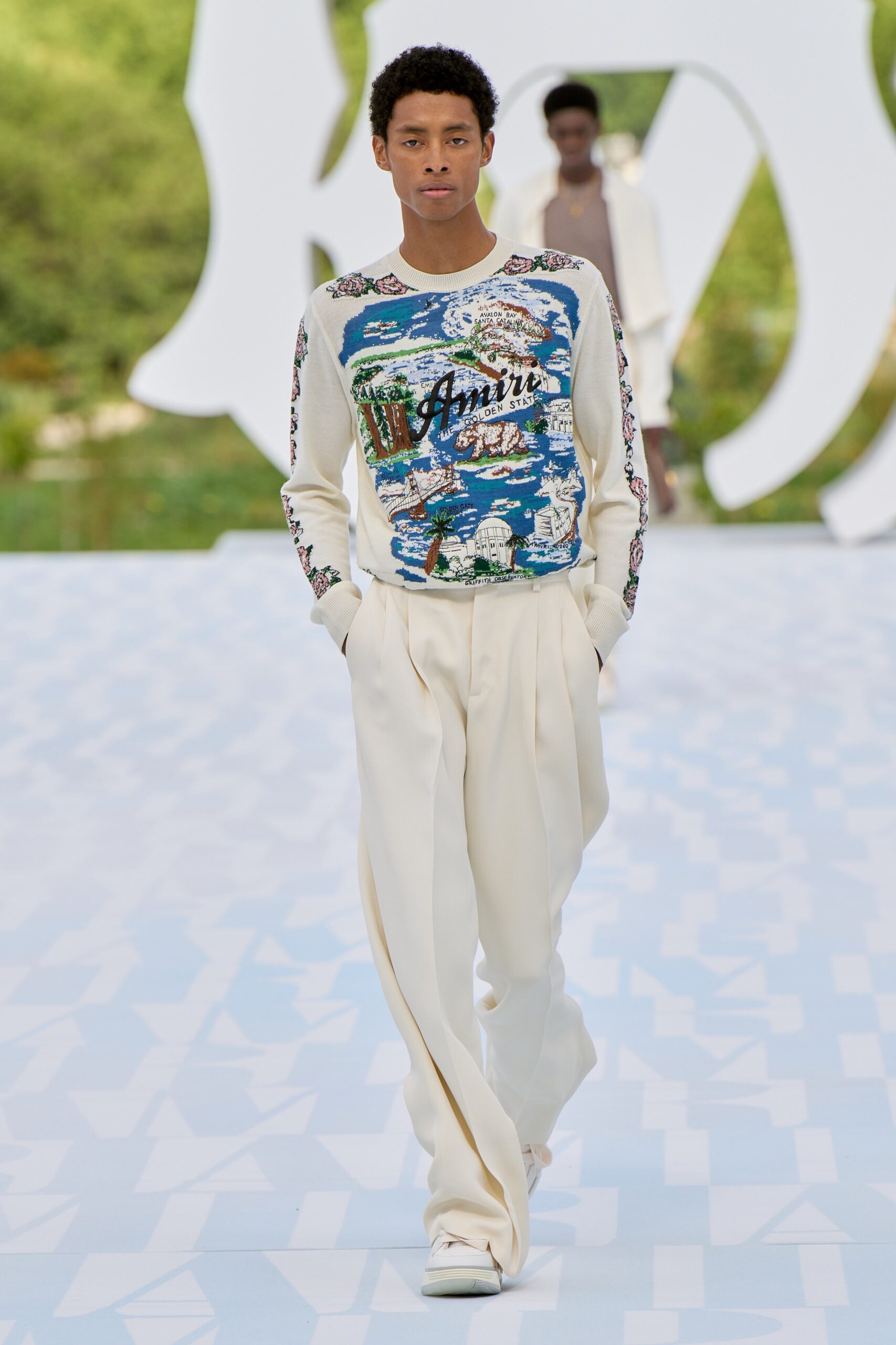white printed sweater and beige pants