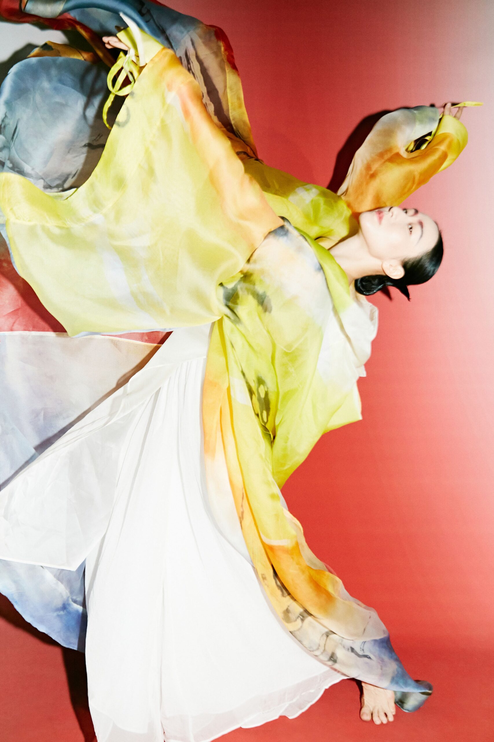 flowing white maxi dress with multi-colored cape