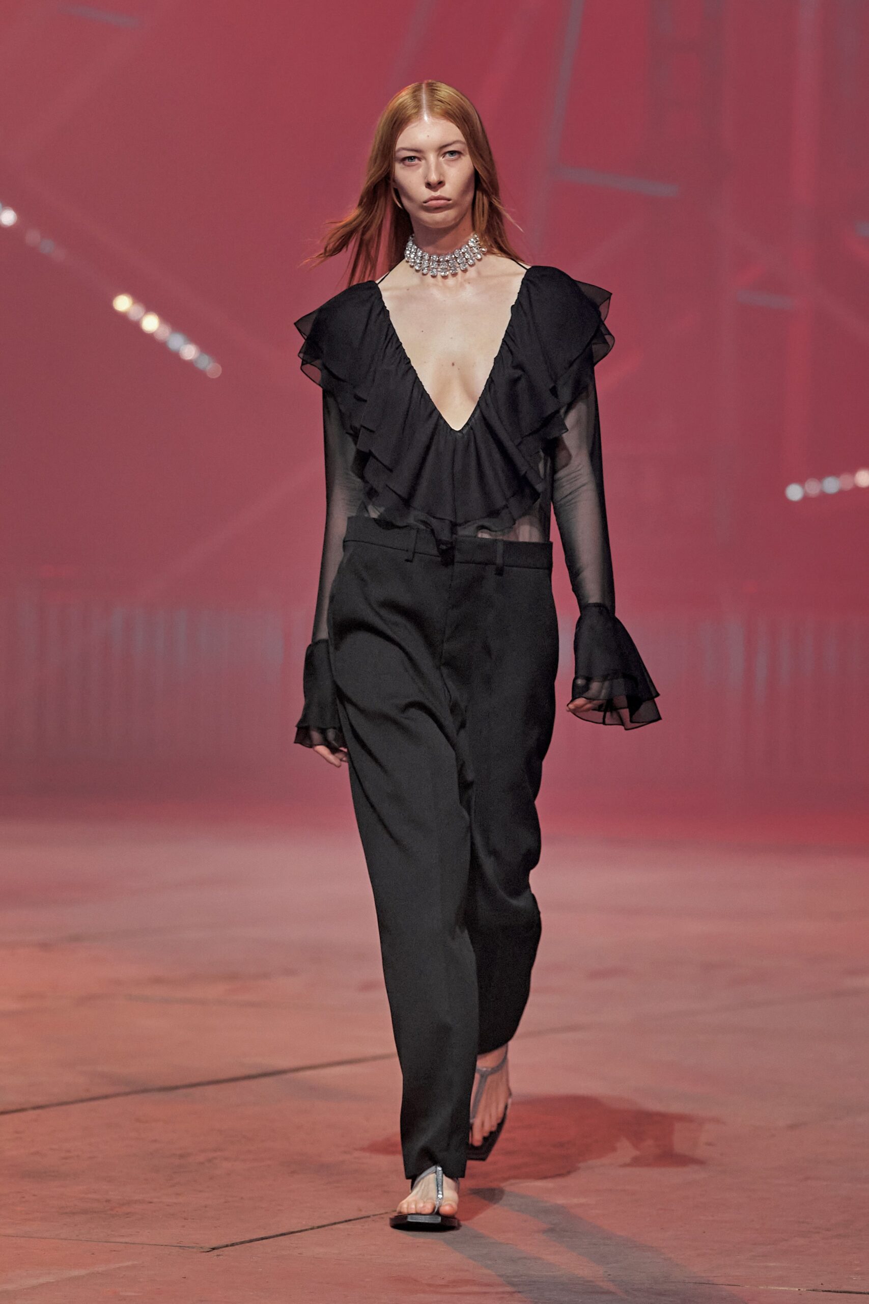 black ruffled blouse and relaxed pants