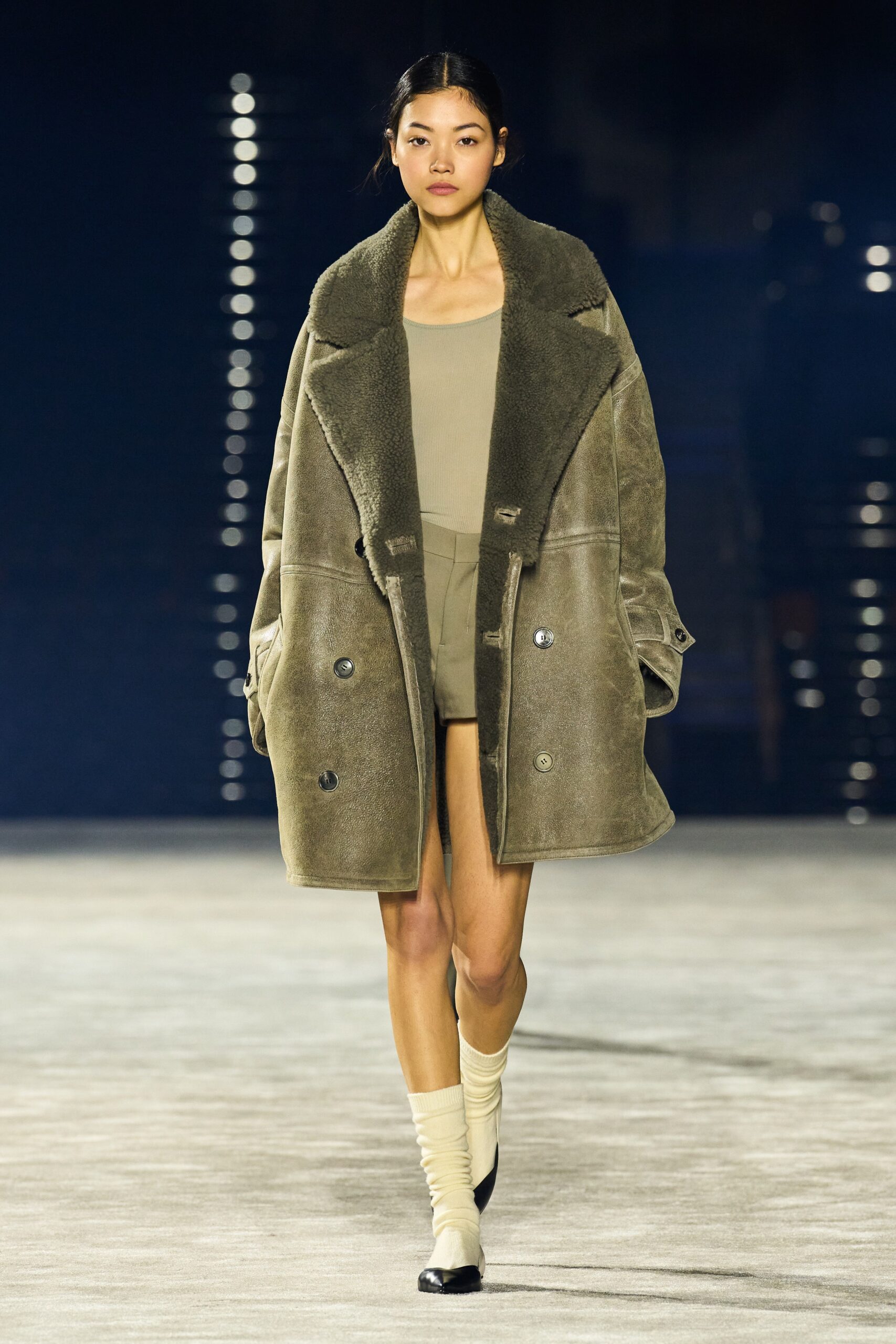 oversized green wool coat with fitted beige dress