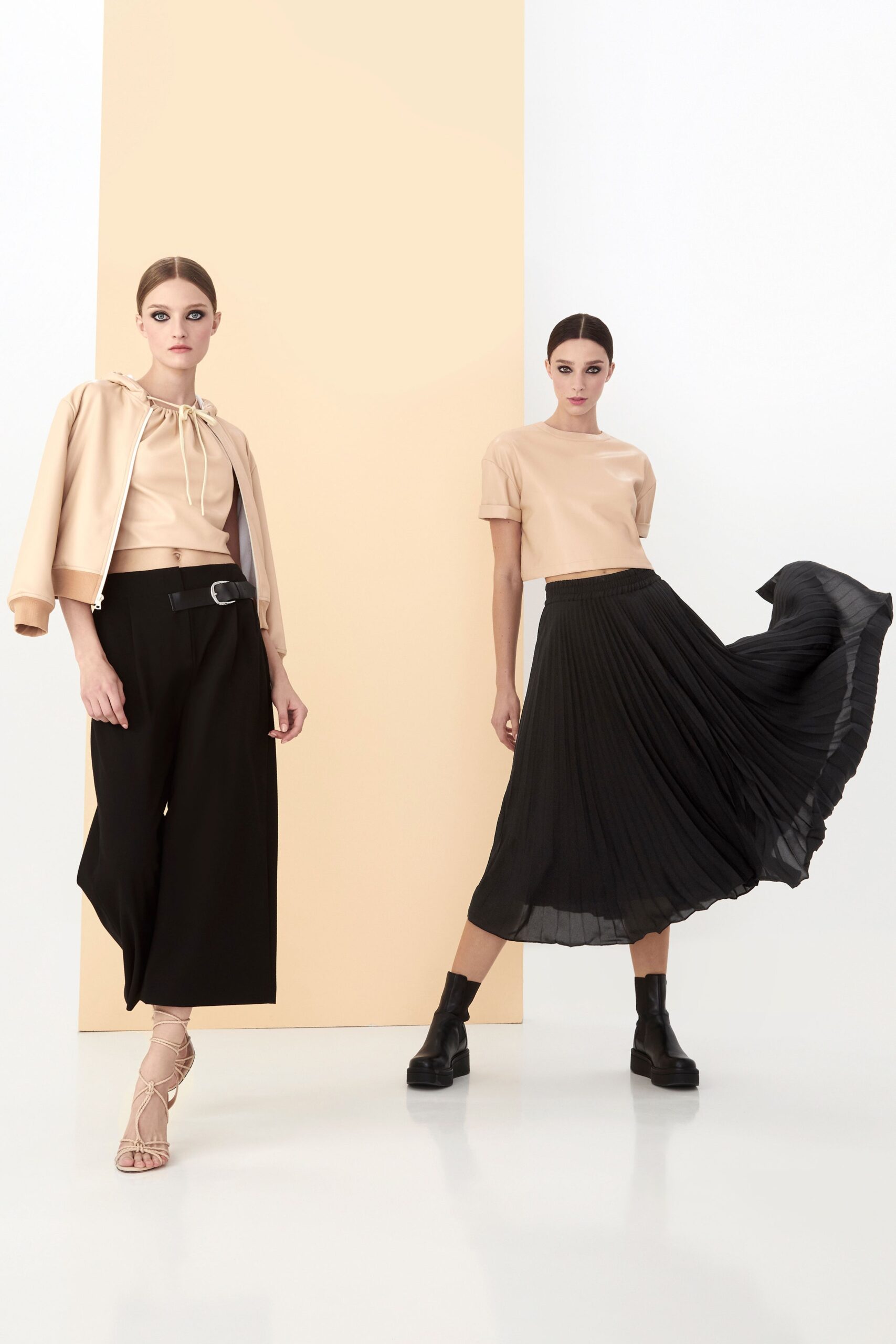 beige top and black pleated skirt