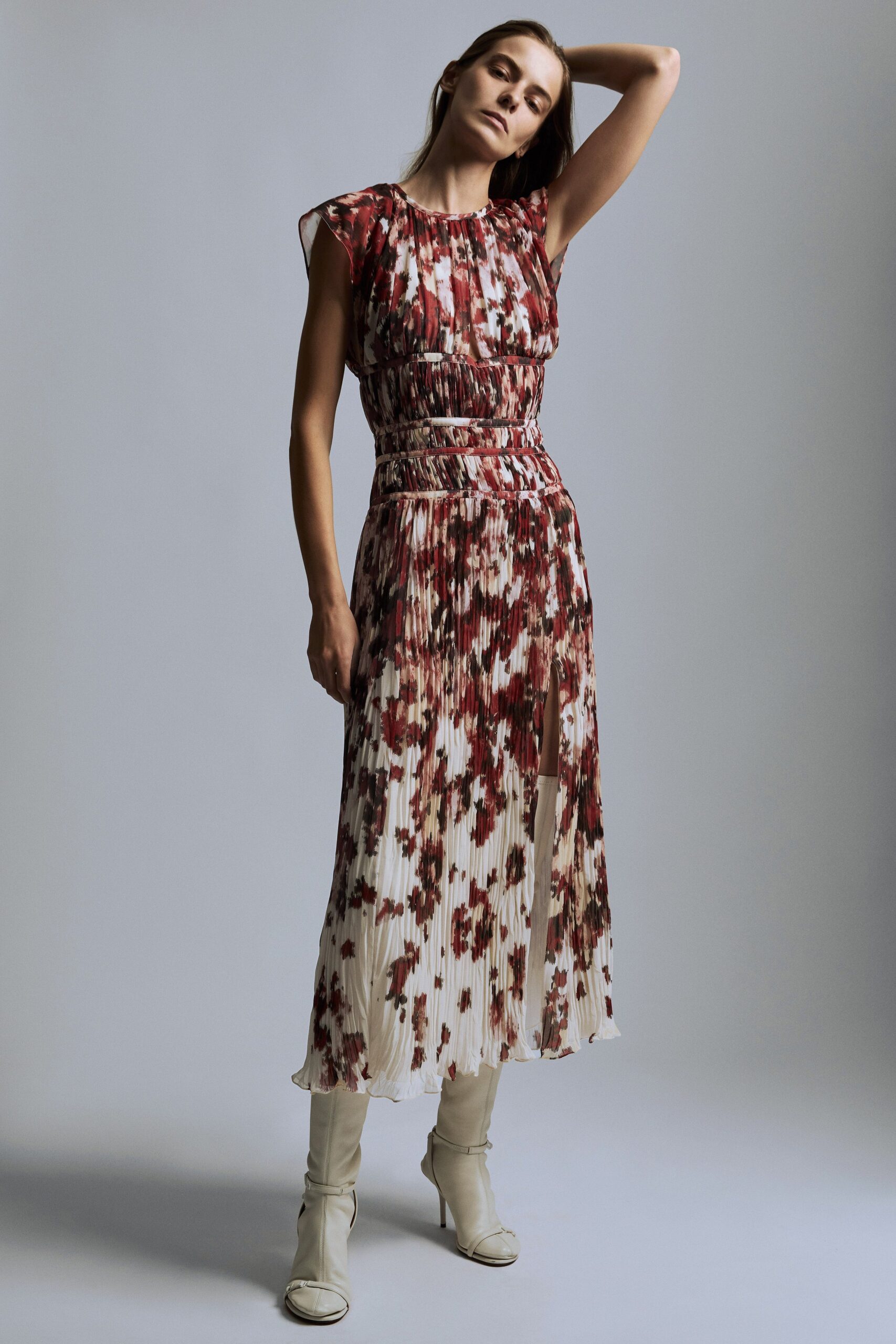red silk sleeveless high-neck fitted pleated flared dress