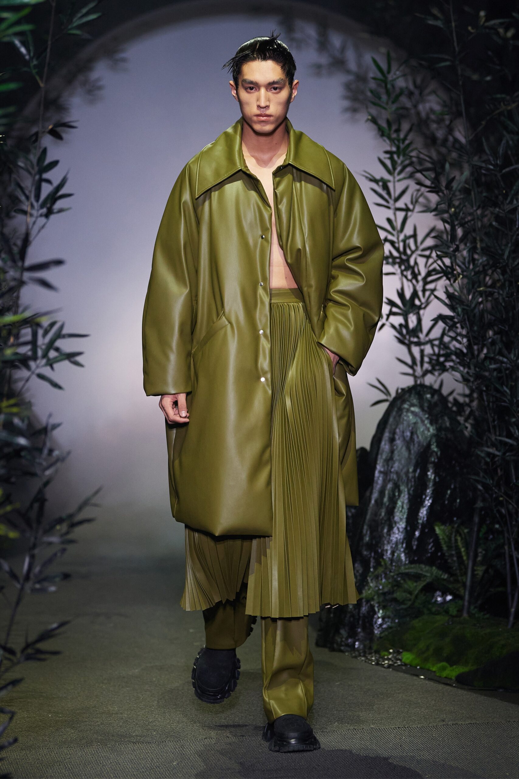 green vinyl oversized coat and pleated skirt