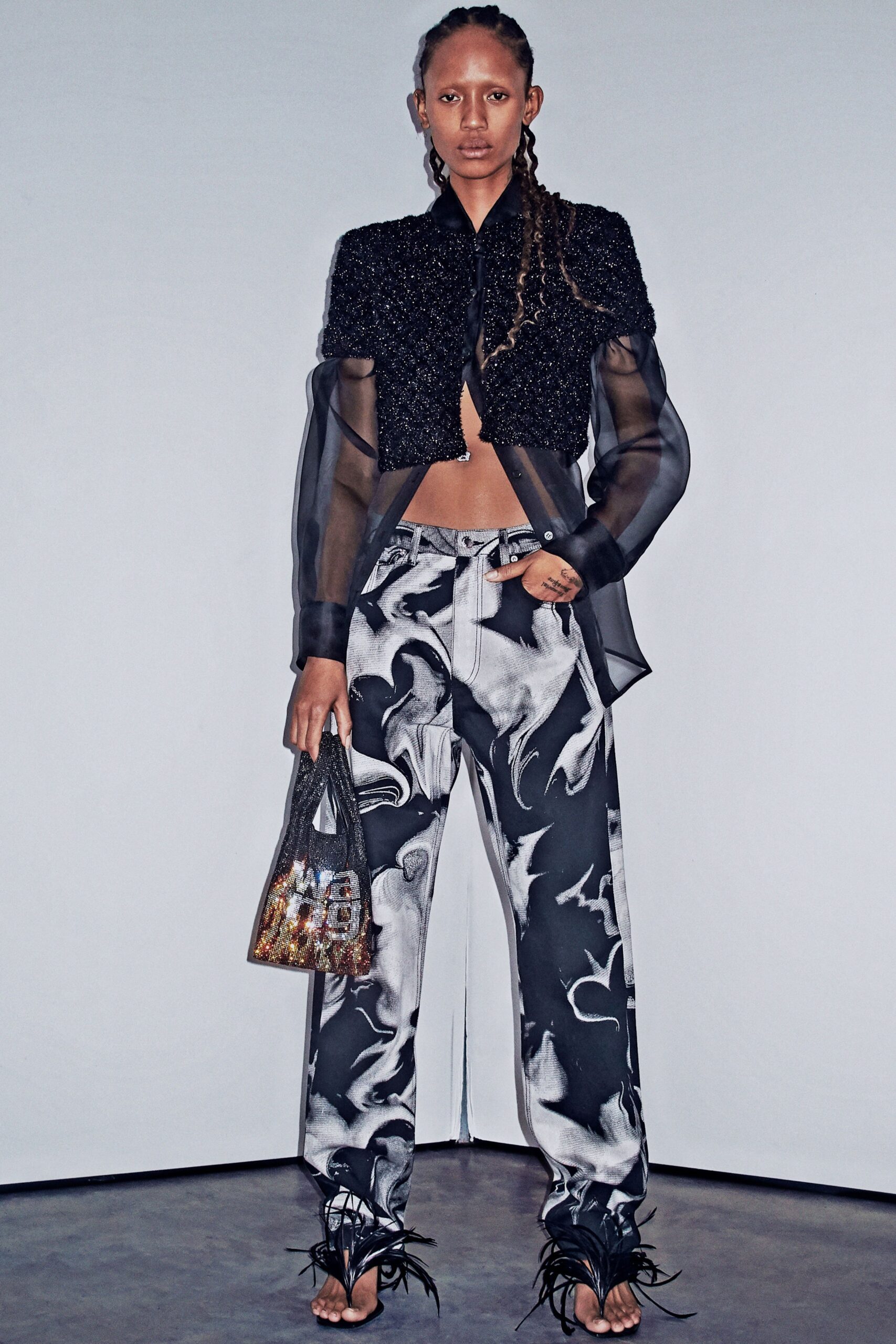 black silk ruffled top with distressed pants