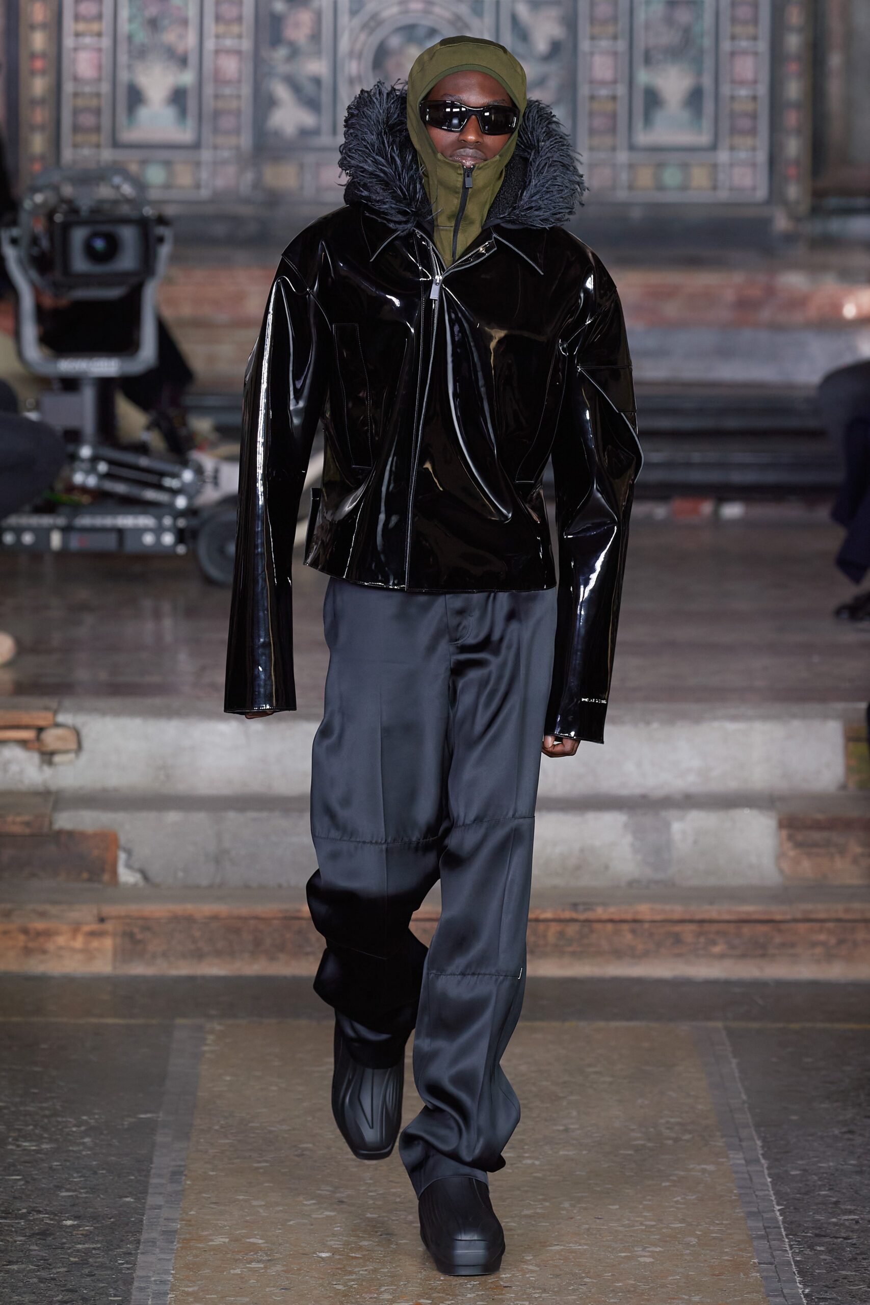 black vinyl fitted jacket with gray pants