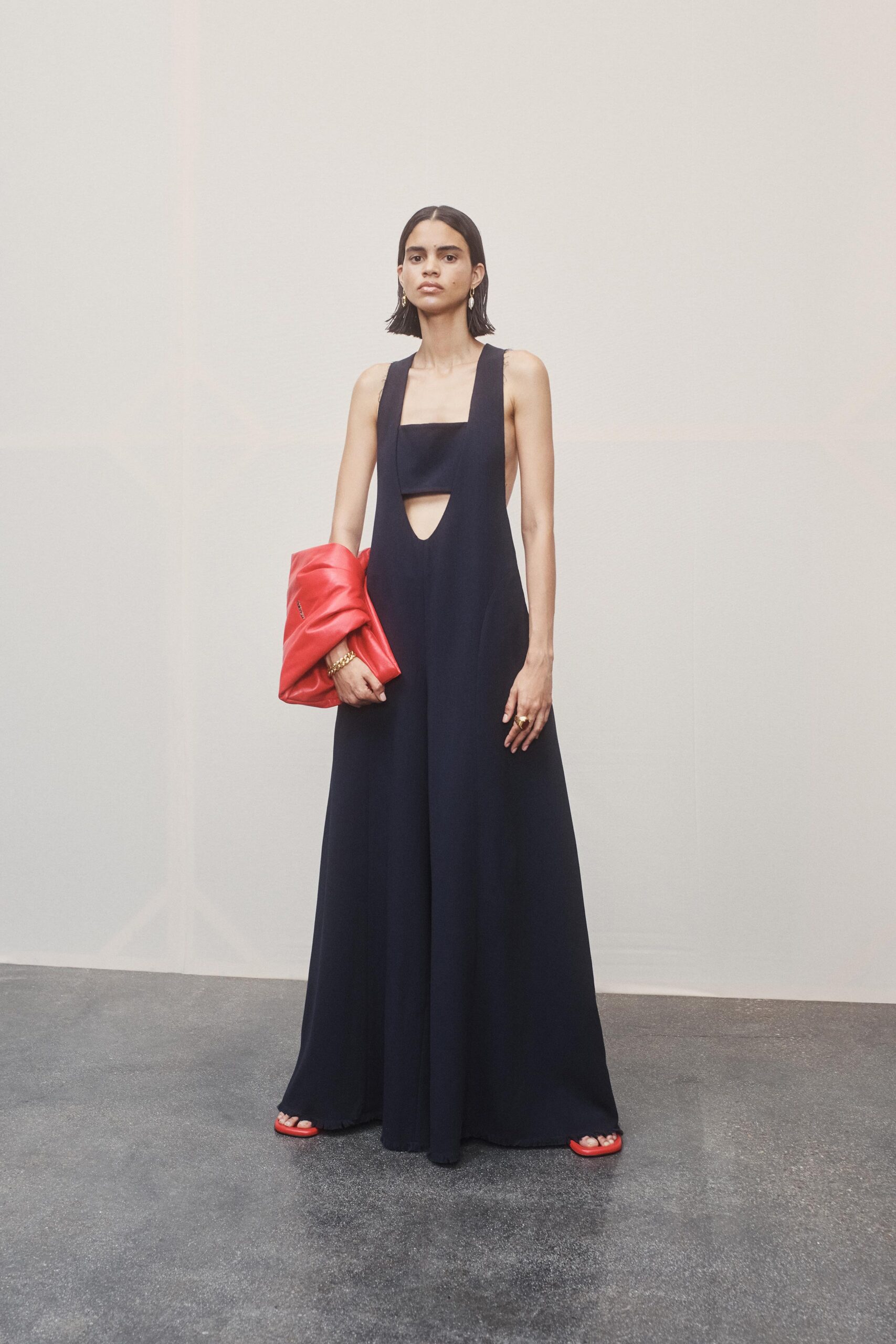 navy cutout maxi dress with red jacket