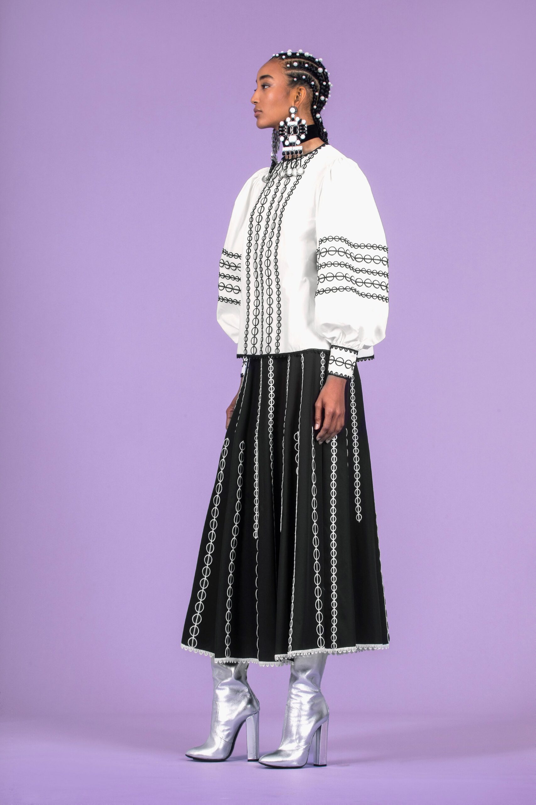 white relaxed blouse black pleated skirt