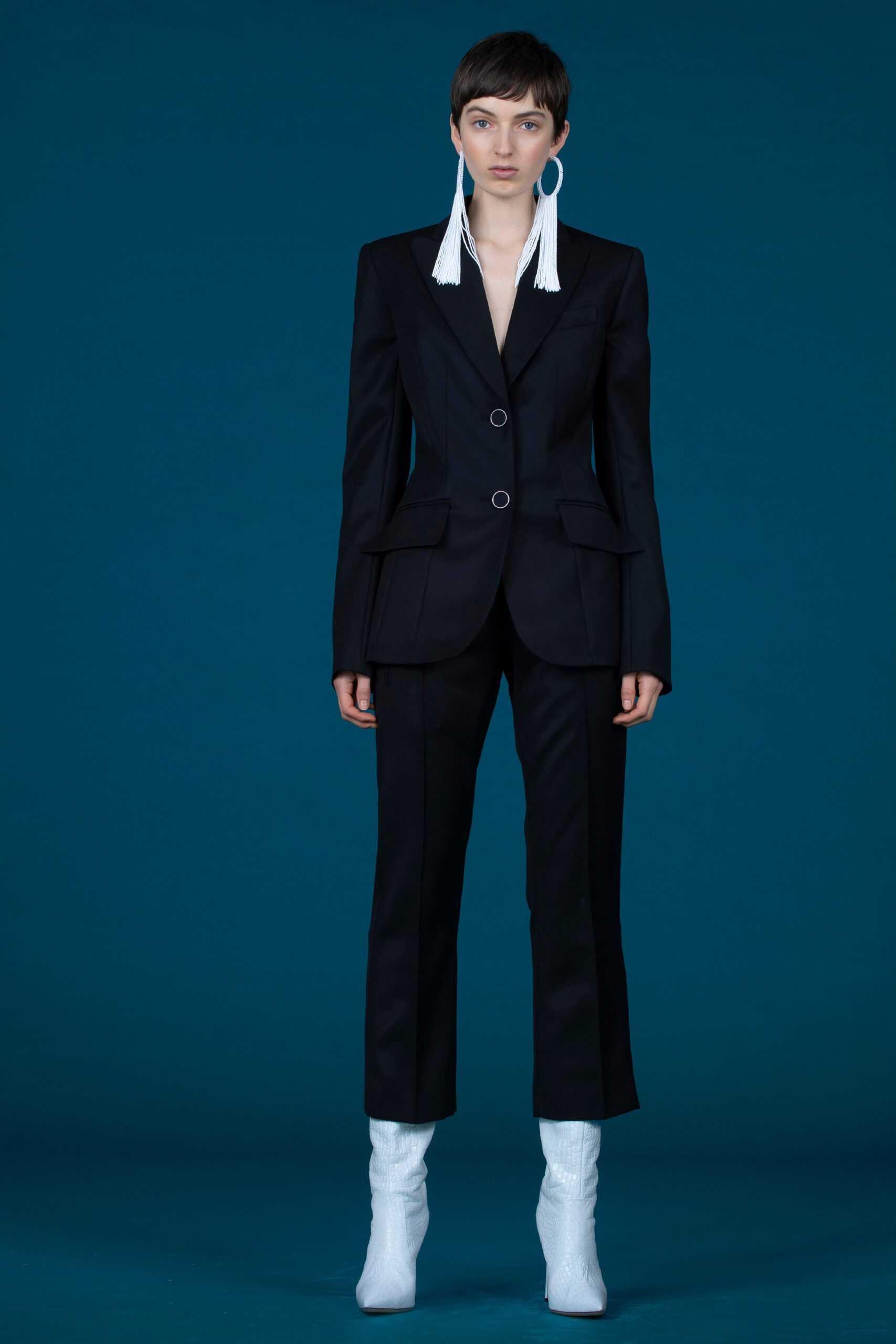 black tailored suit with white shoes