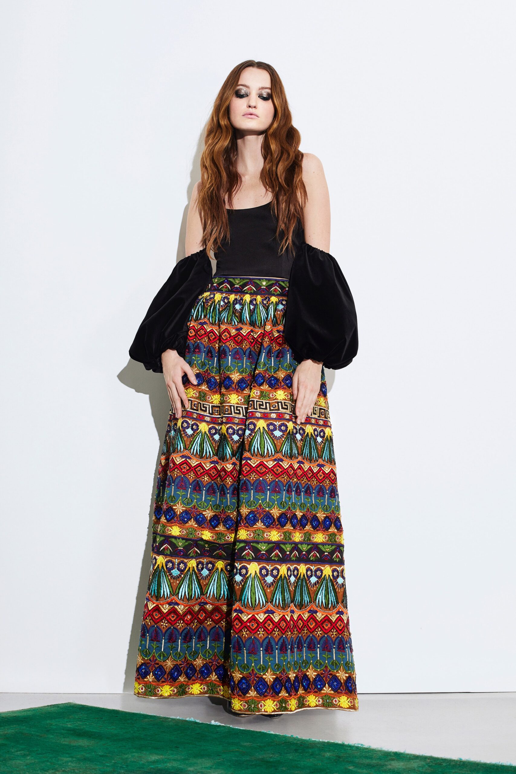black fitted top with multi-colored pants