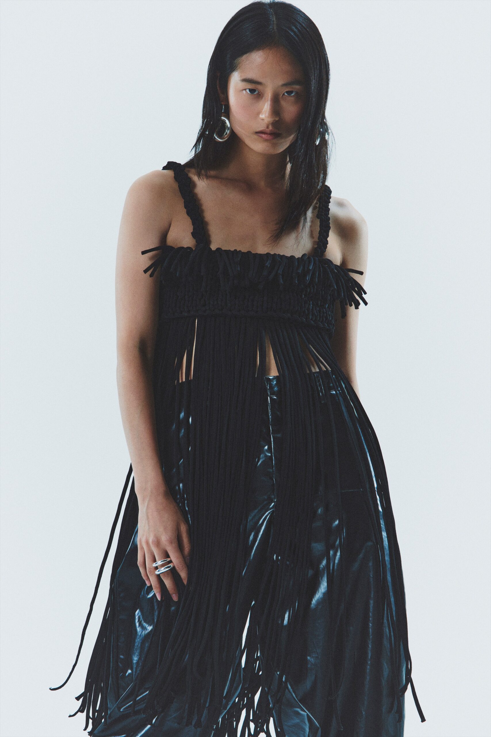 black fringed top with leather pants