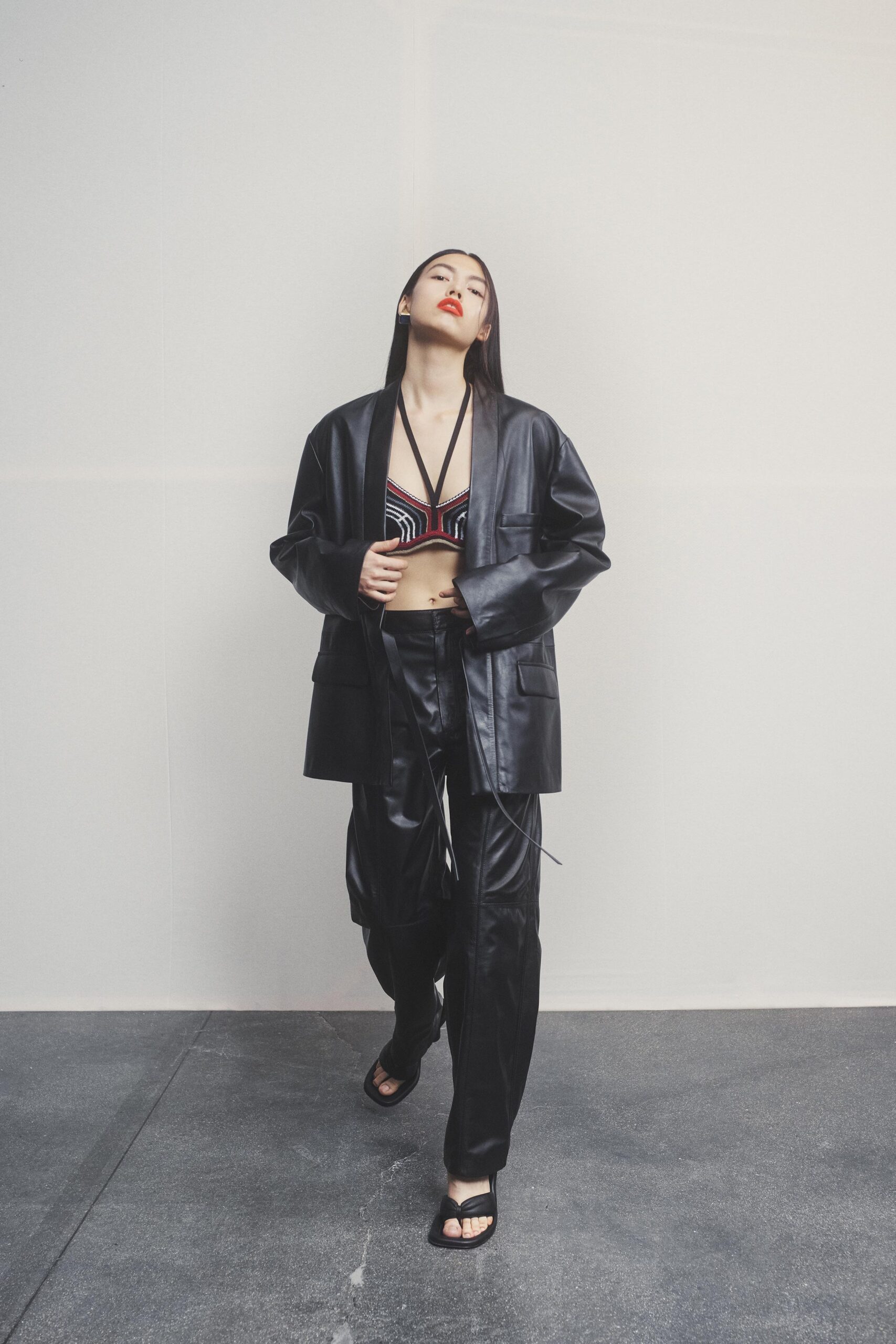 black leather long-sleeve collared oversized buttoned jacket