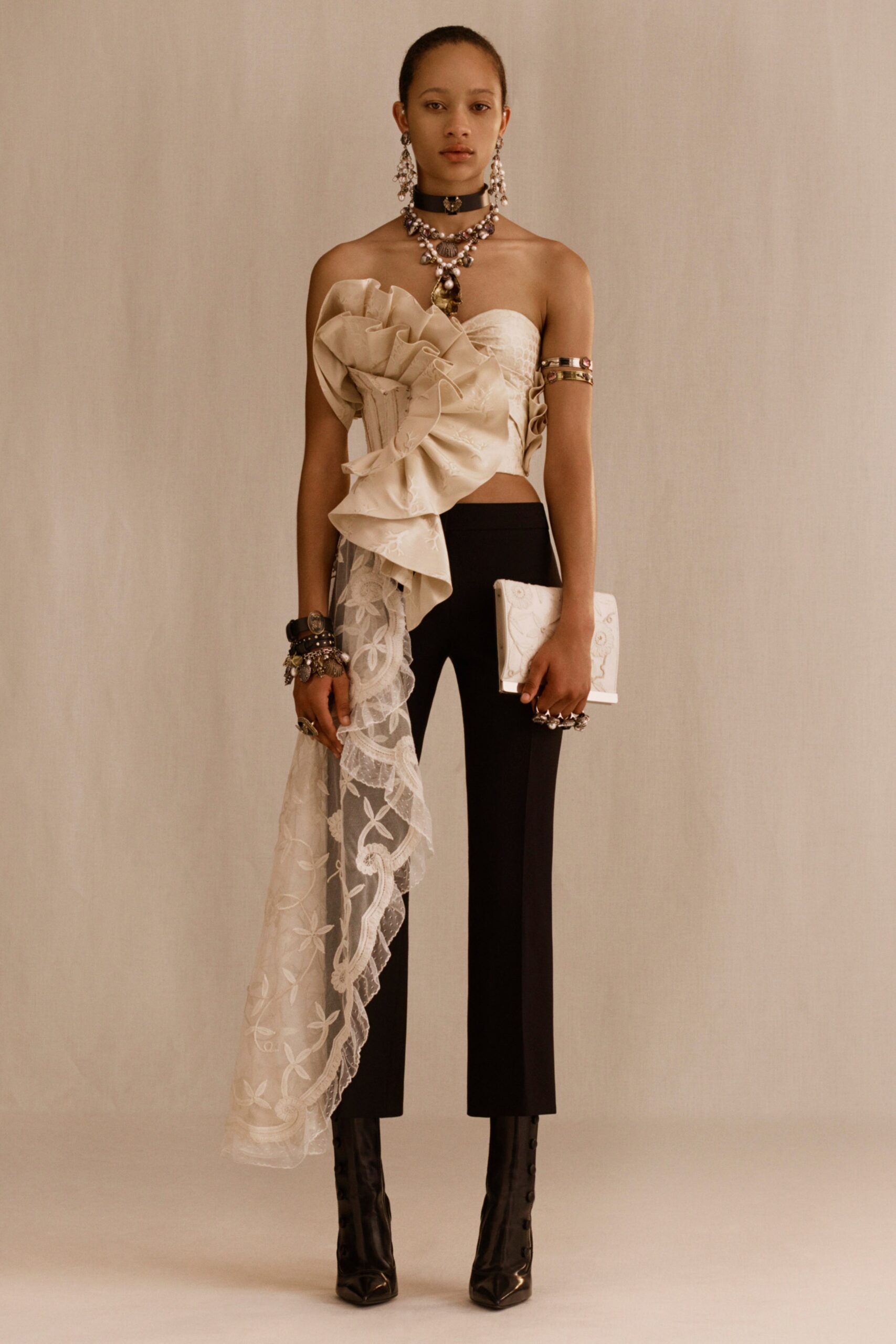 beige ruffled top with black pants