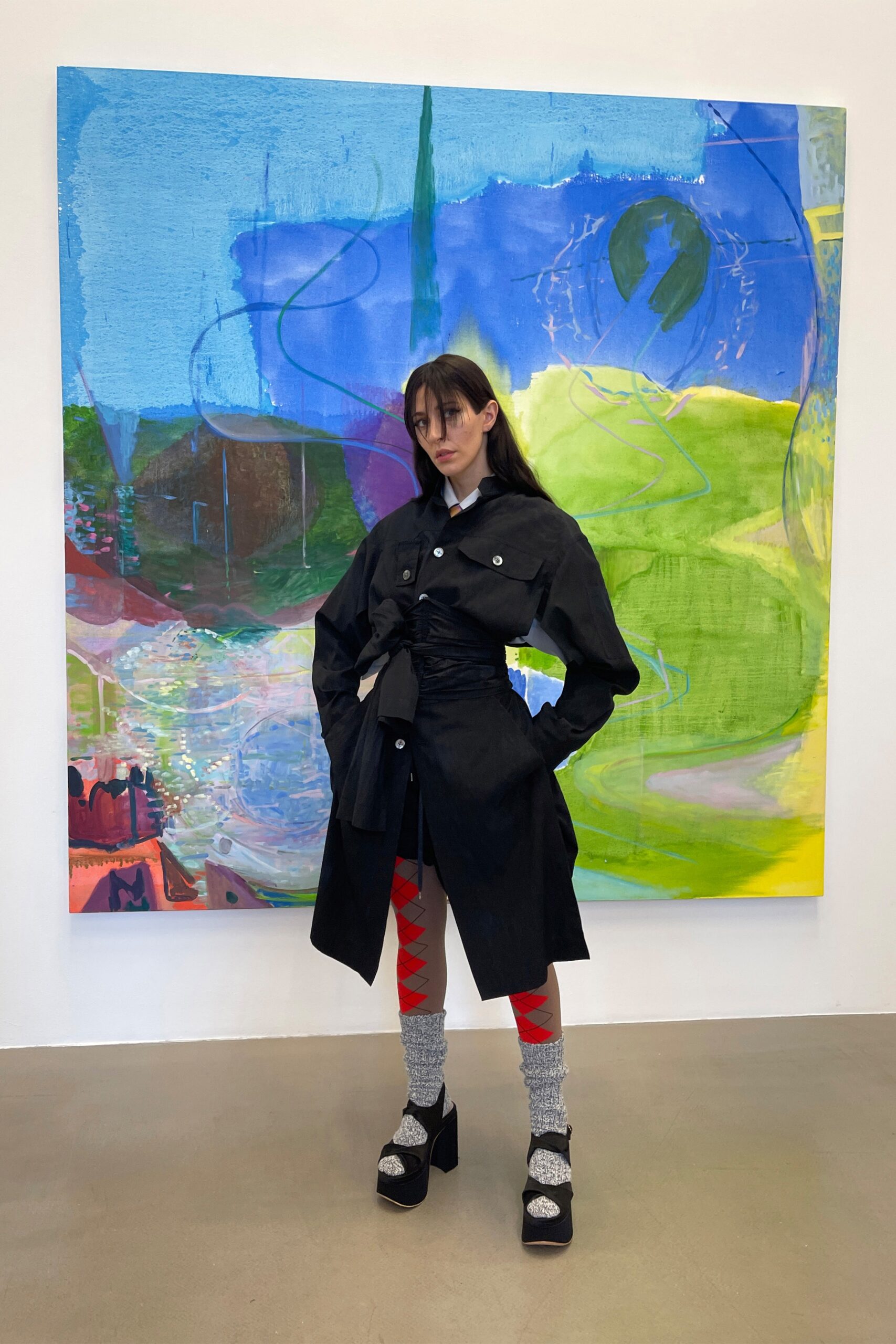 black fitted coat with red cargo pants