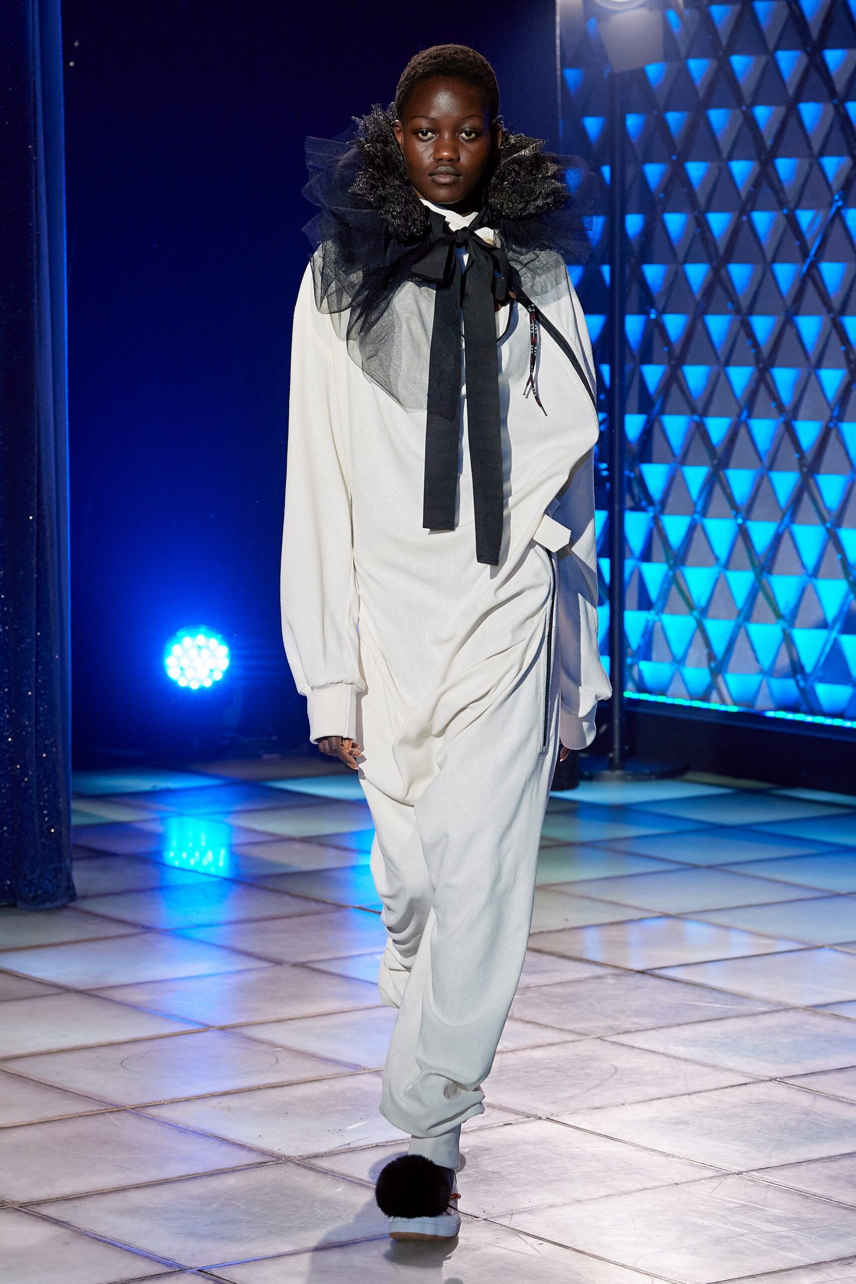 white relaxed jumpsuit with ruffled accessory