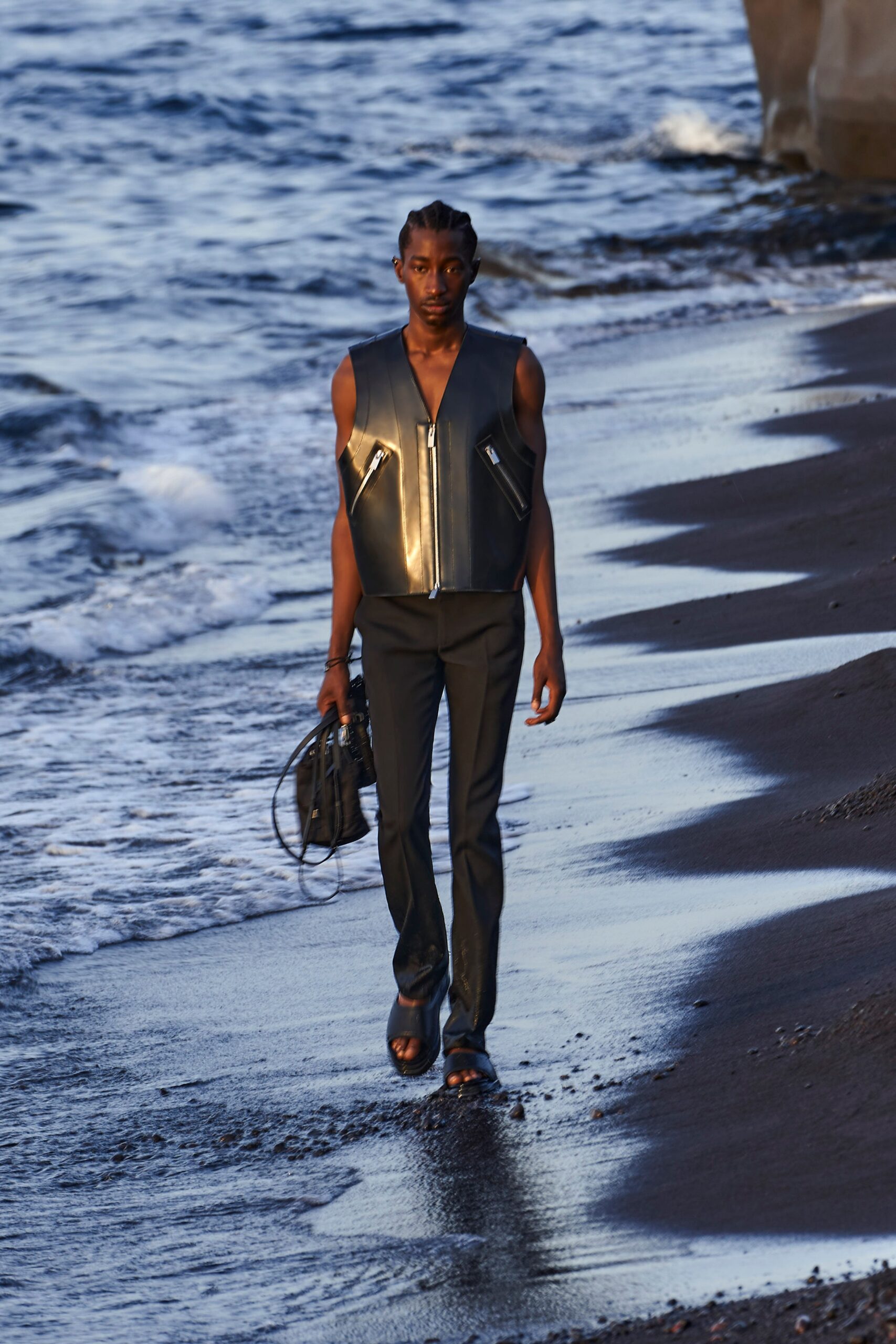 black leather fitted vest and tailored pants