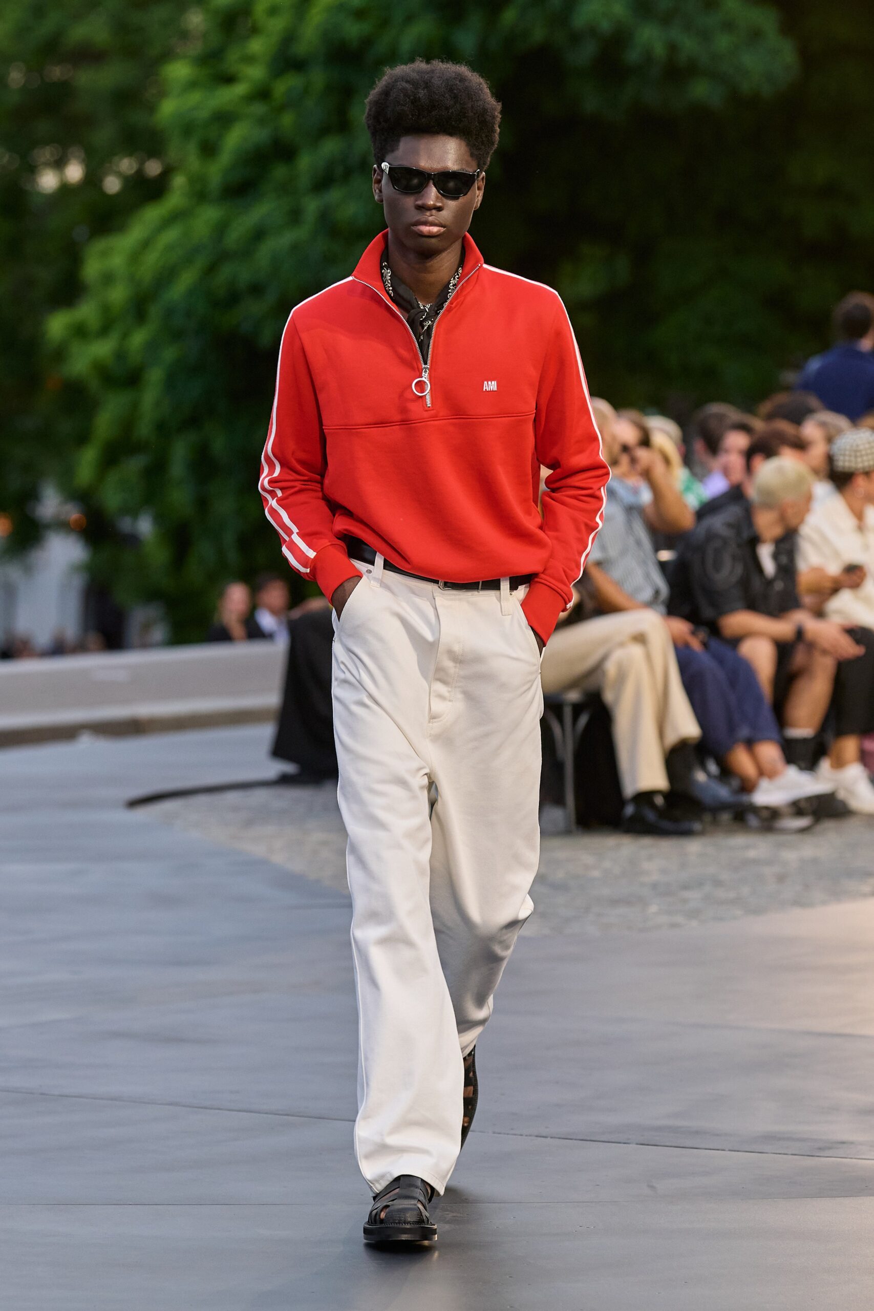 red fitted top with white pants