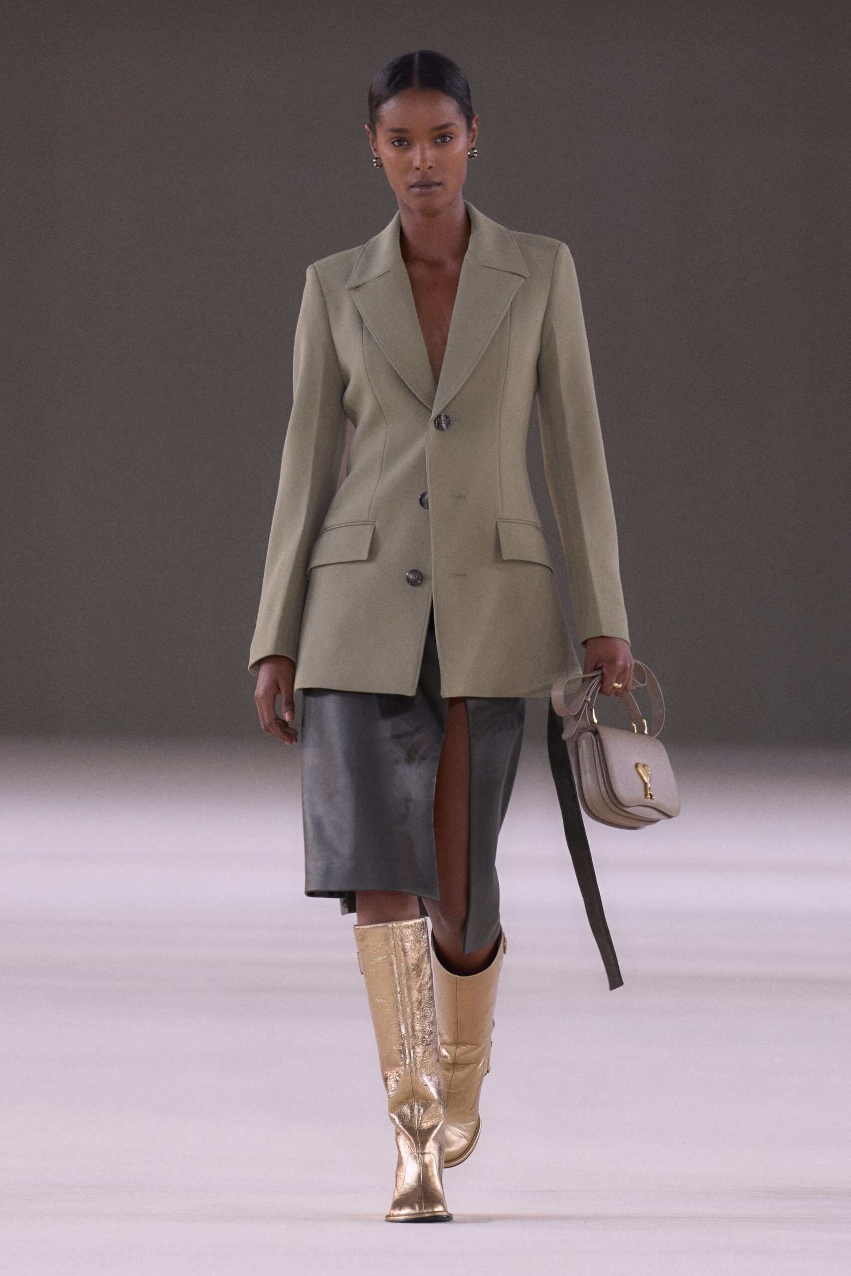 green tailored blazer with black leather skirt
