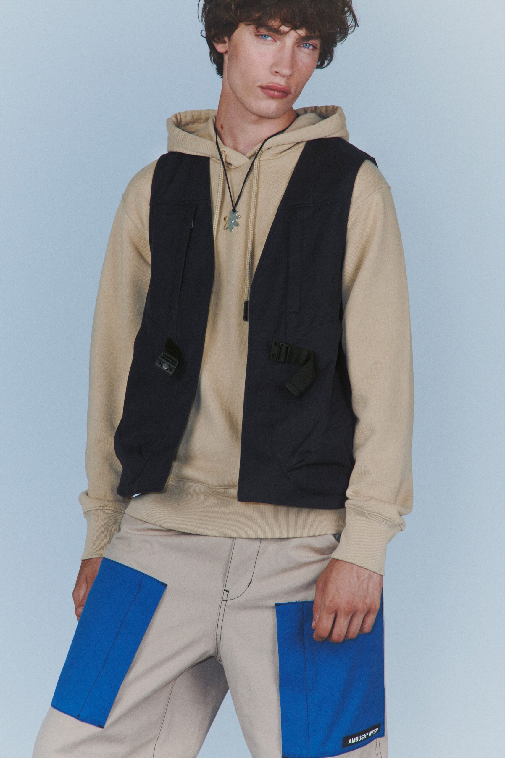 beige hoodie black vest cargo pants
