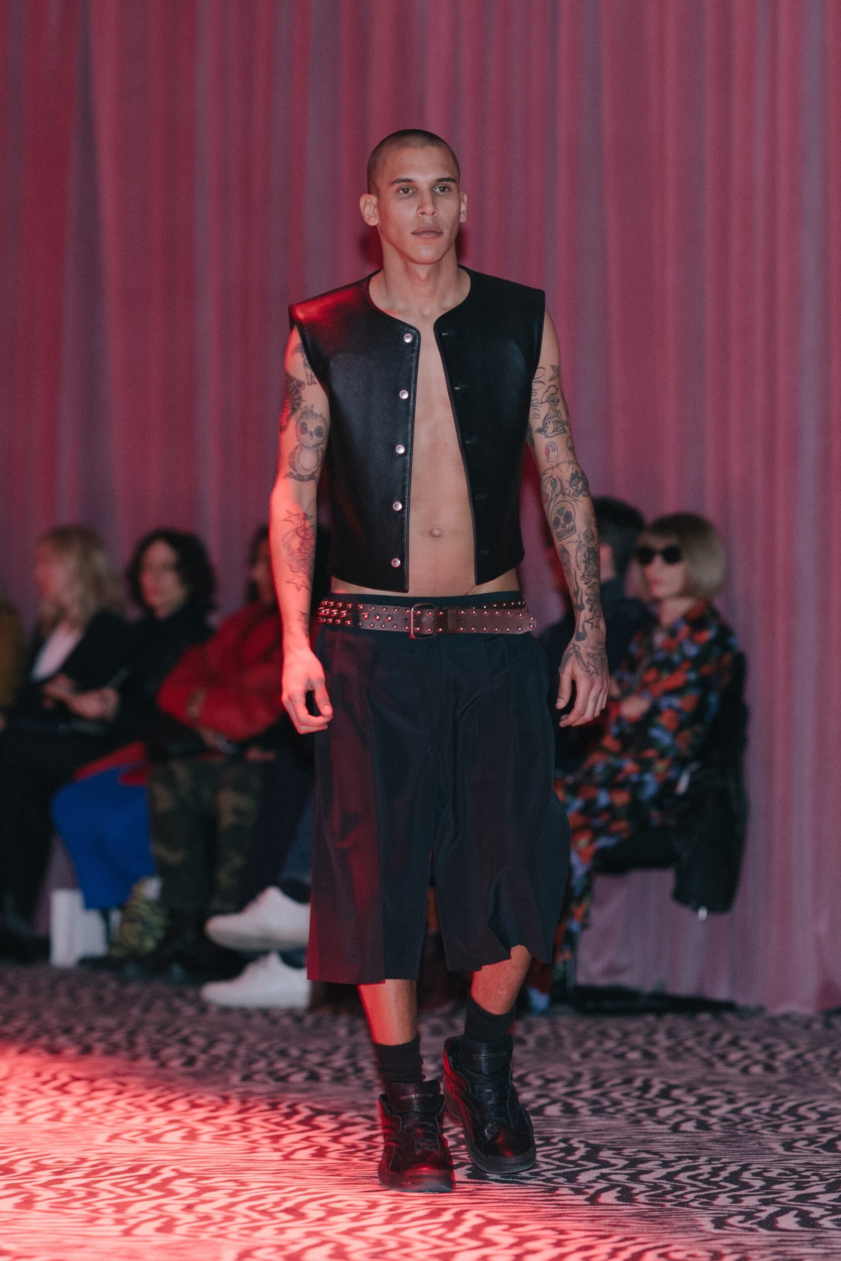 black leather vest and relaxed pants