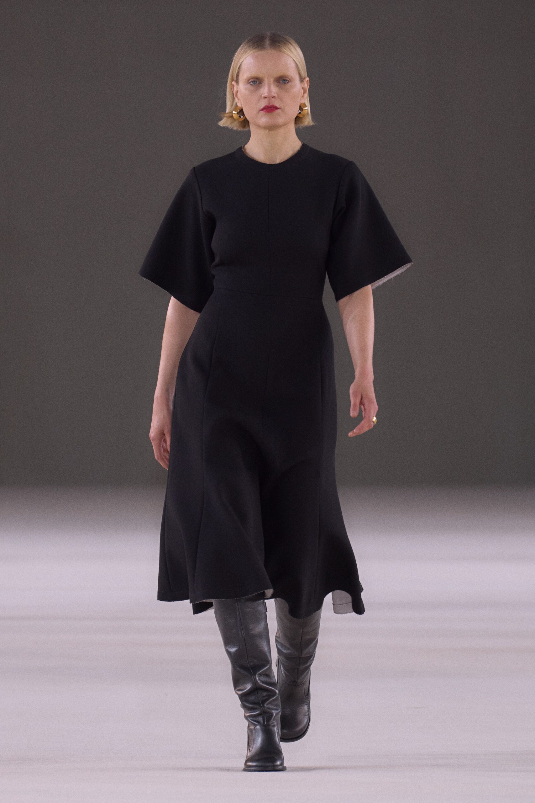black midi dress with knee-high boots