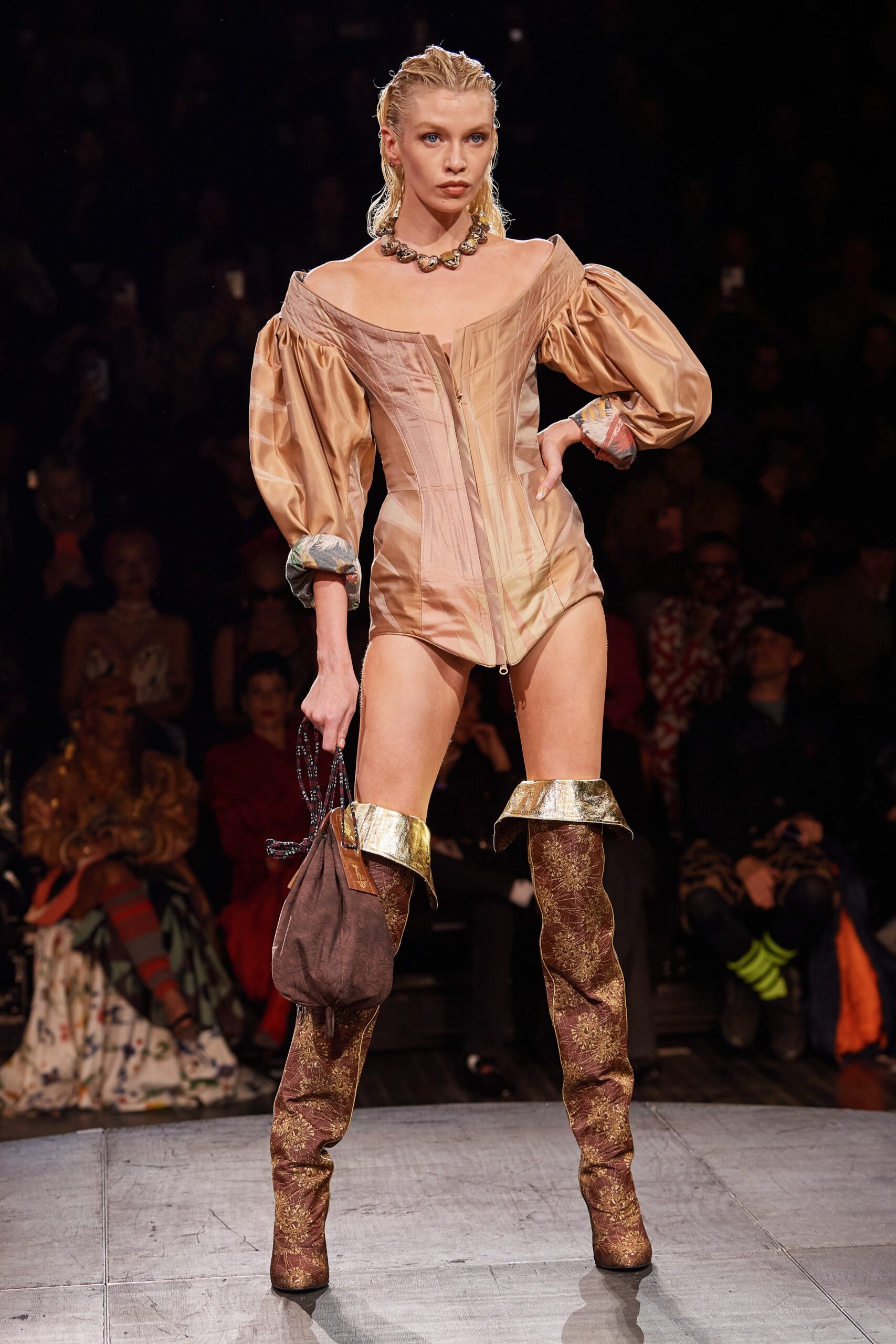 beige silk bodysuit with gold boots