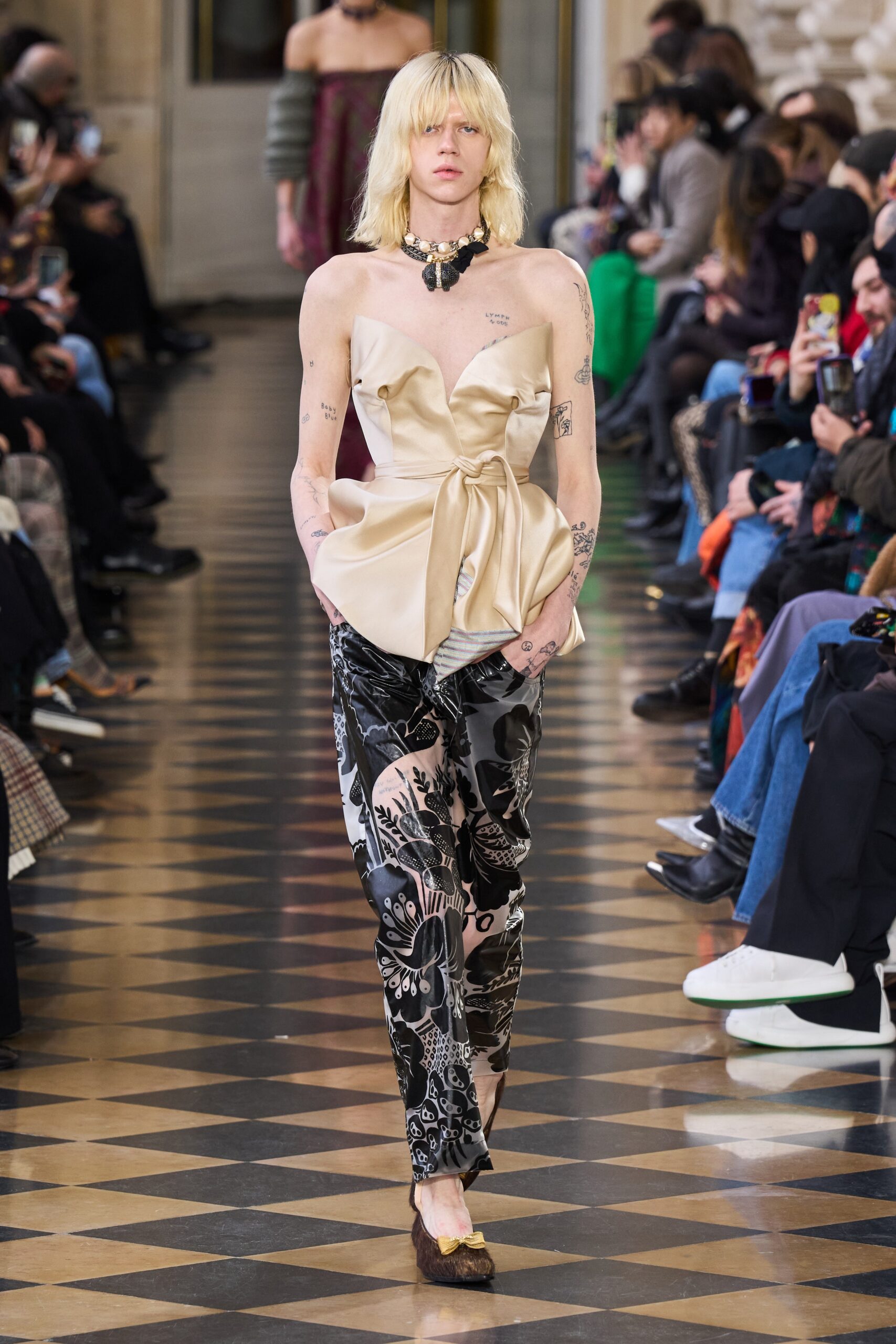 beige silk strapless top and black flared pants