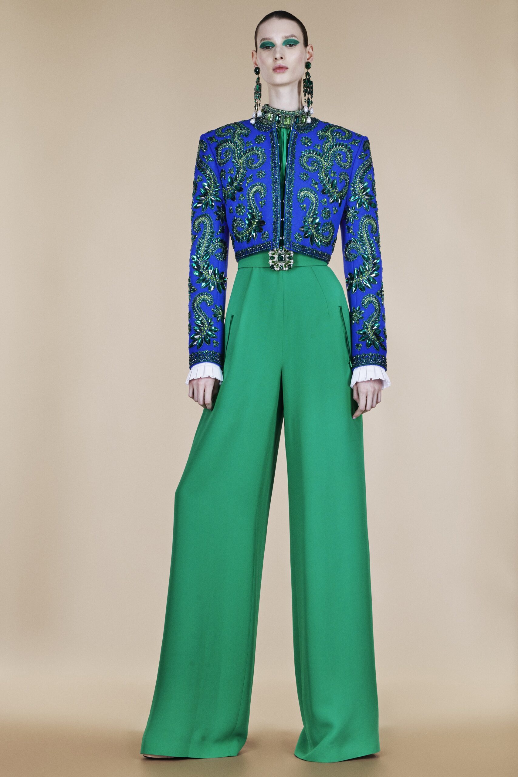 blue embroidered jacket and green wide-leg pants