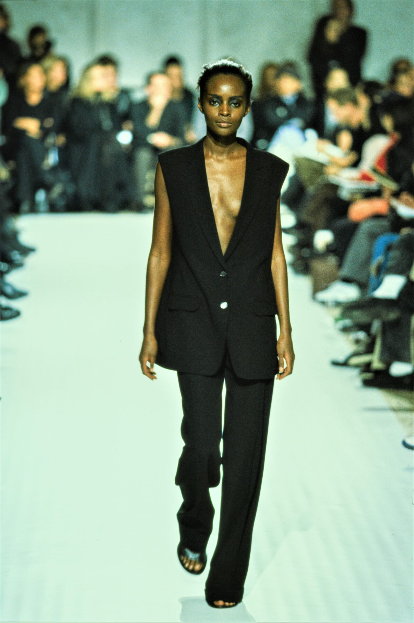 black sleeveless blazer and tailored pants