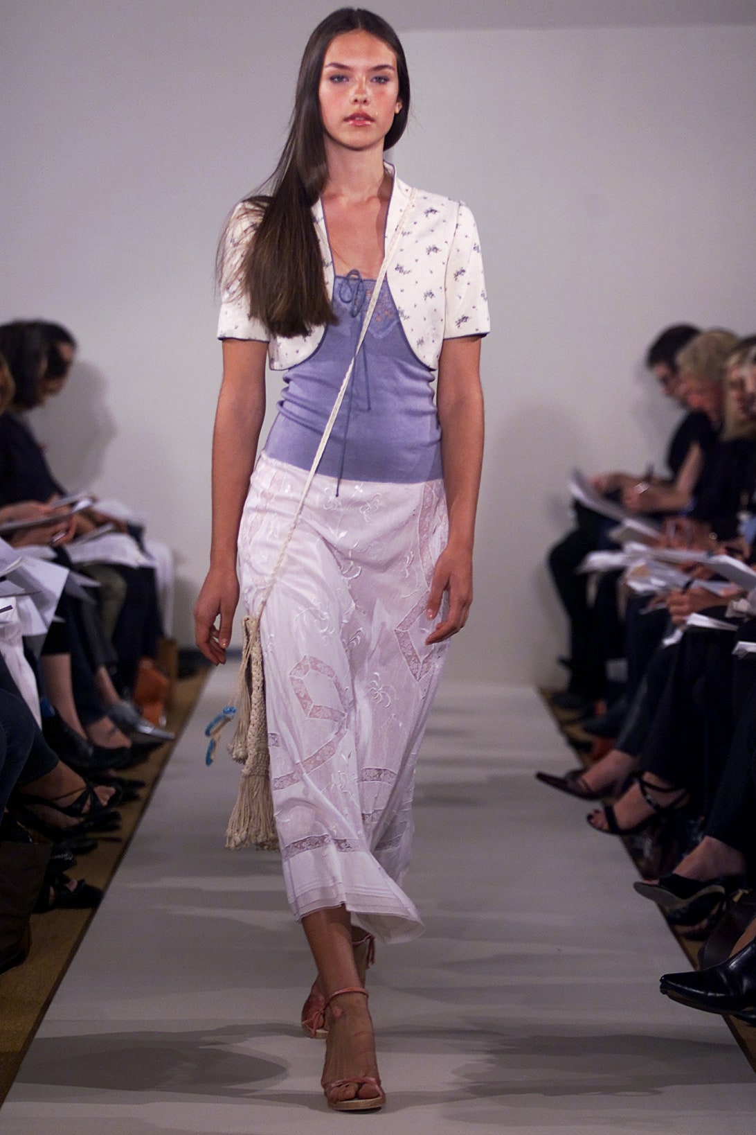 blue silk sleeveless top and white pleated skirt
