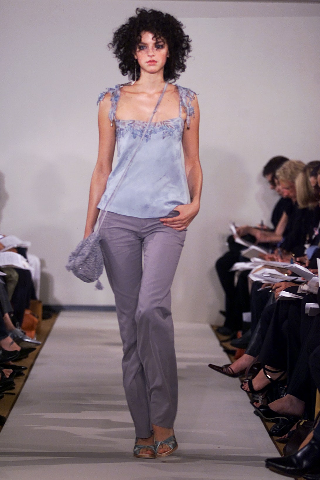 blue silk sleeveless top and gray pants
