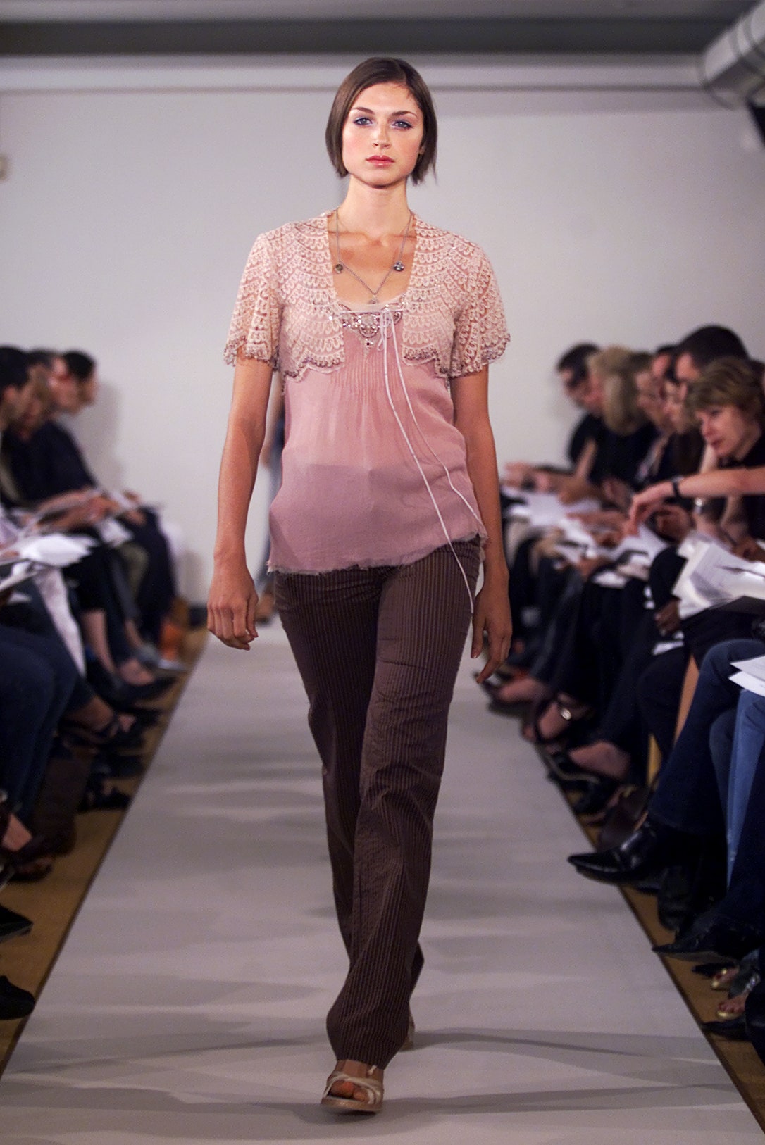 pink silk fitted top with brown pants