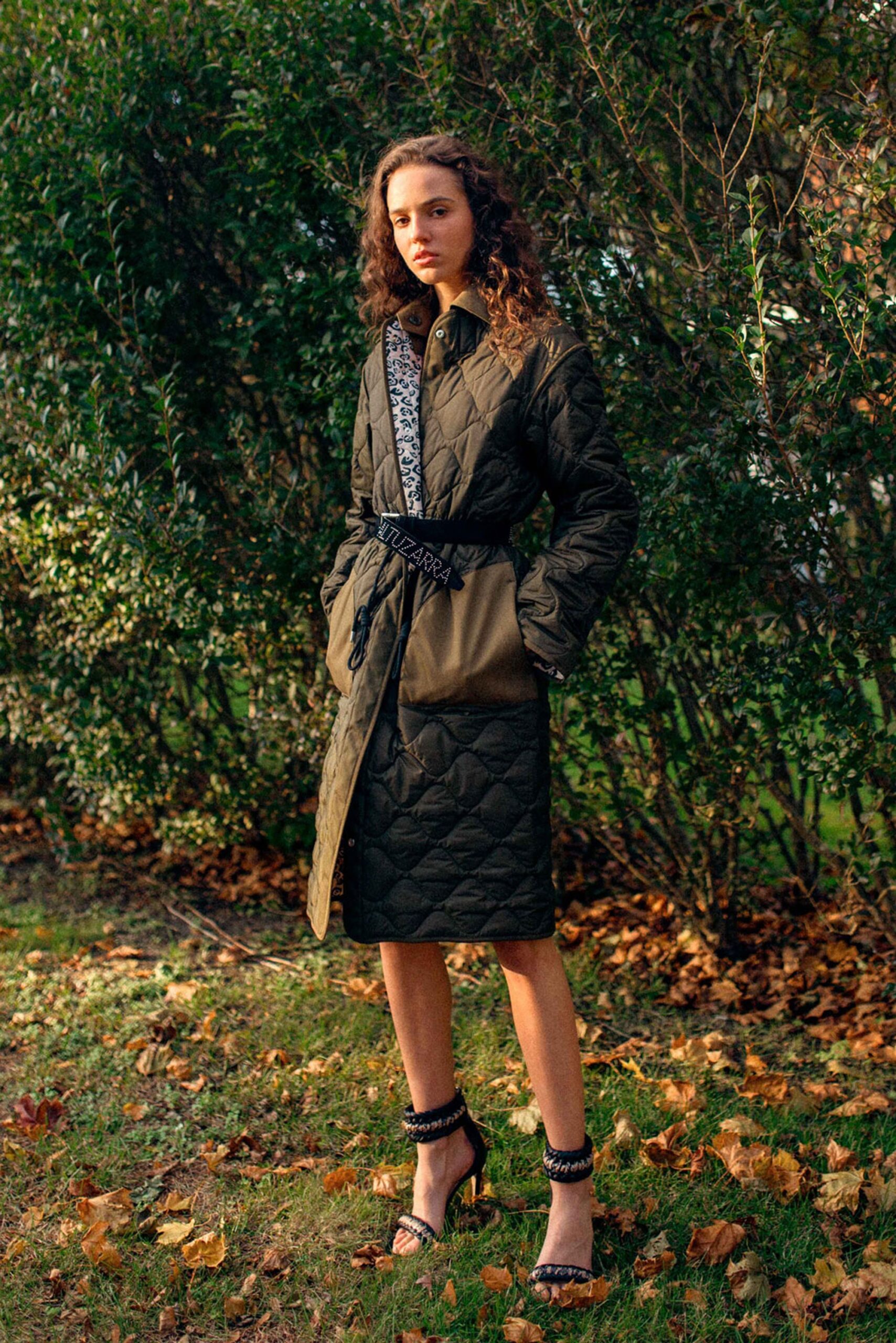 green quilted coat with strappy heels