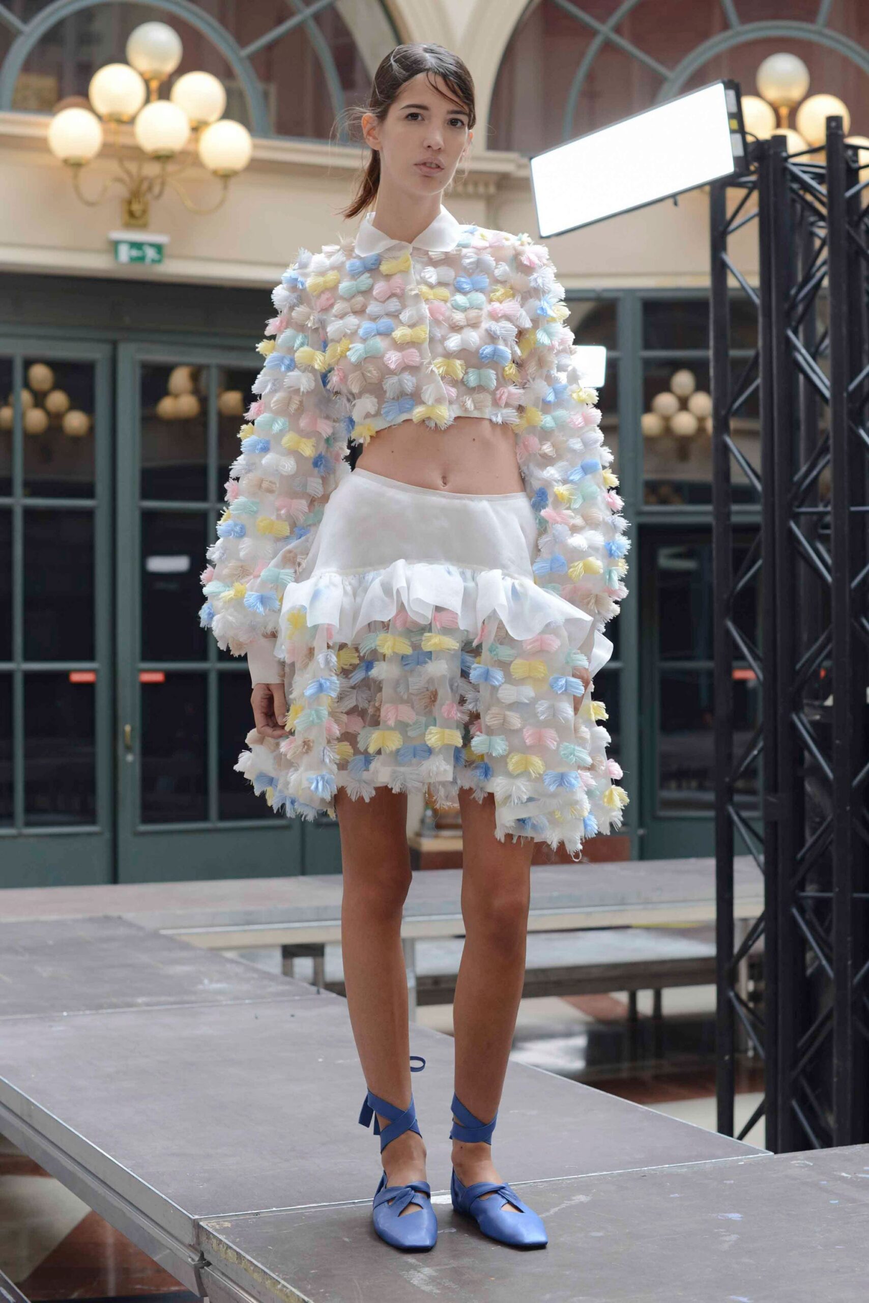multi-colored ruffled top with white mini skirt